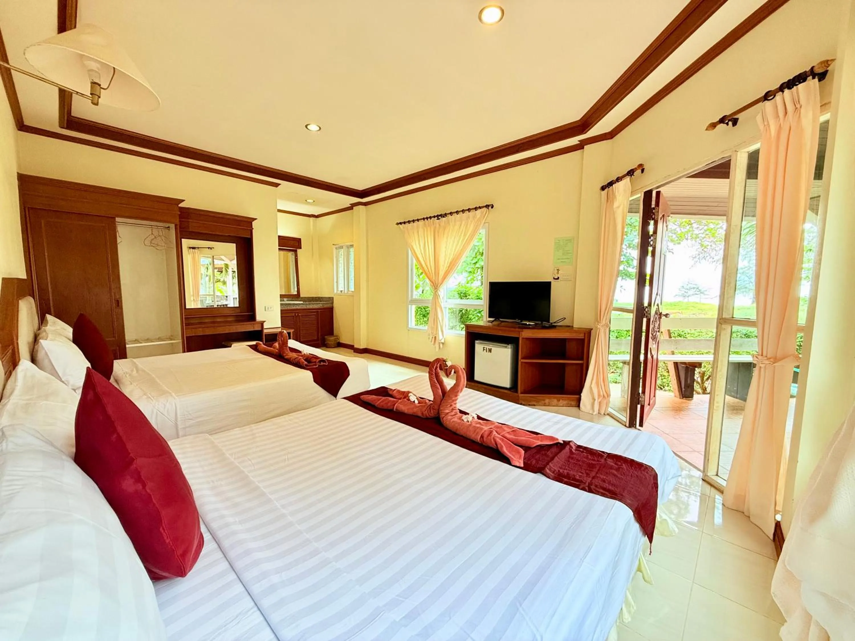 Bed in Lanta Palm Beach Resort , Beach Bungalow - Koh Lanta