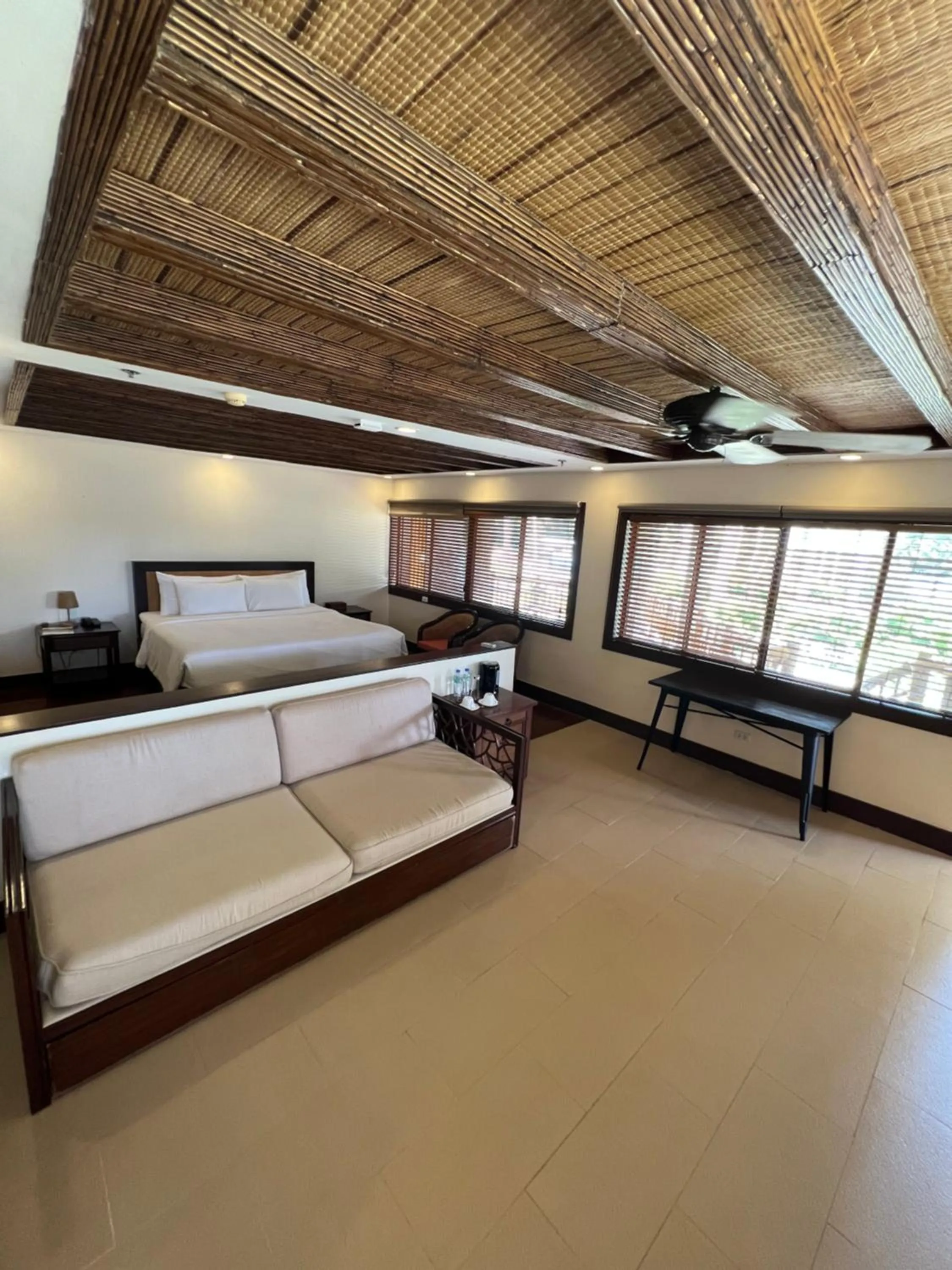 Seating area, Bed in Fridays Puerto Galera