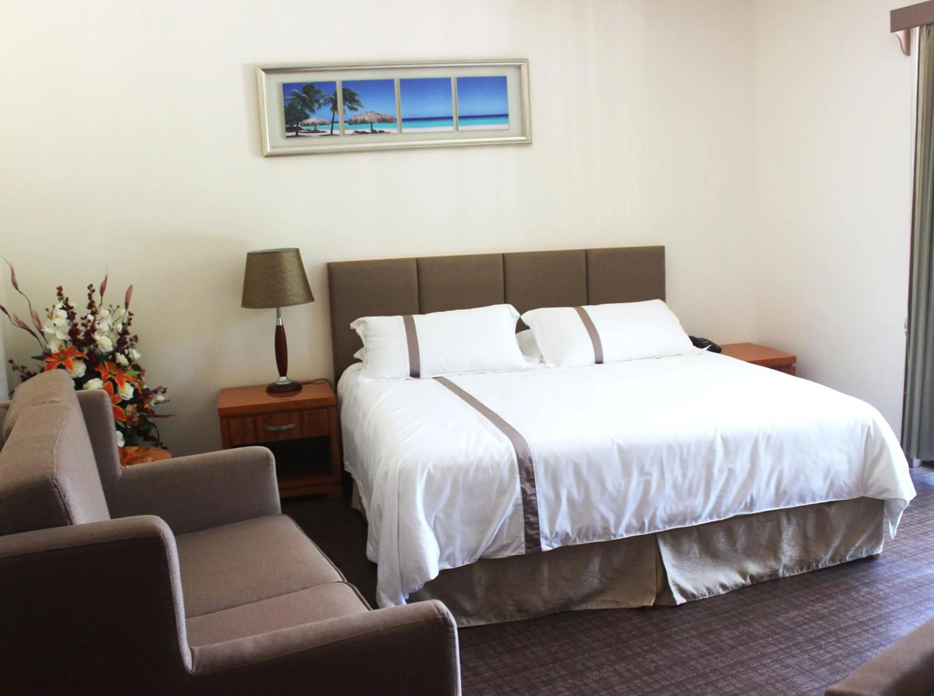 Seating area, Bed in Saipan Beach Hotel
