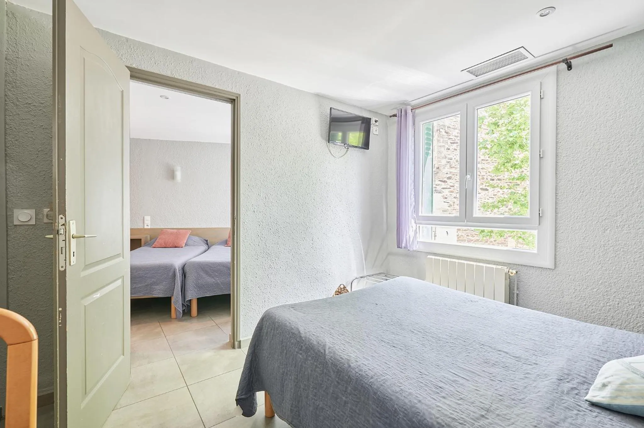 Bed in Logis Hôtel le Triton