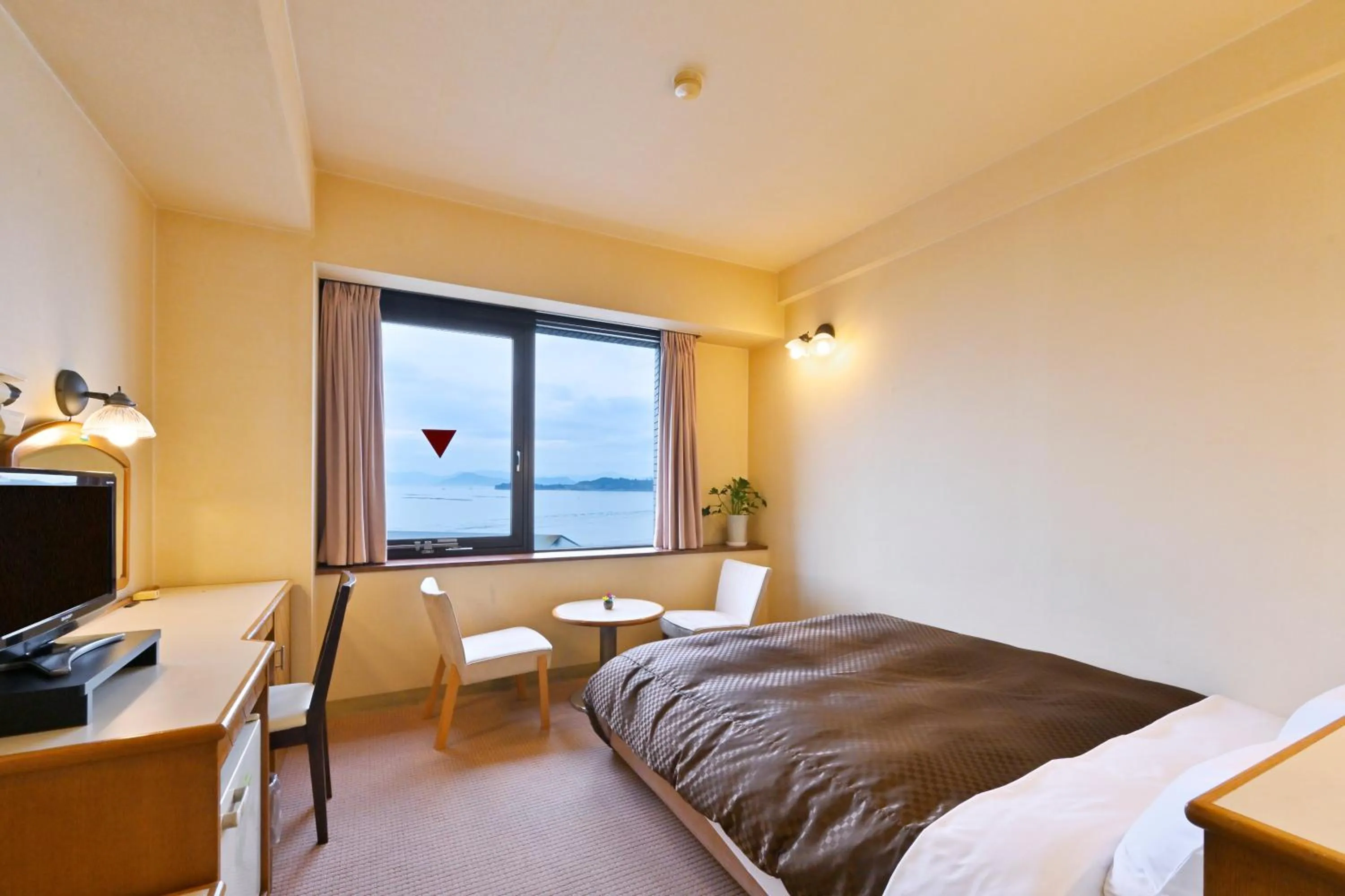 Bed in Miyajima Coral Hotel