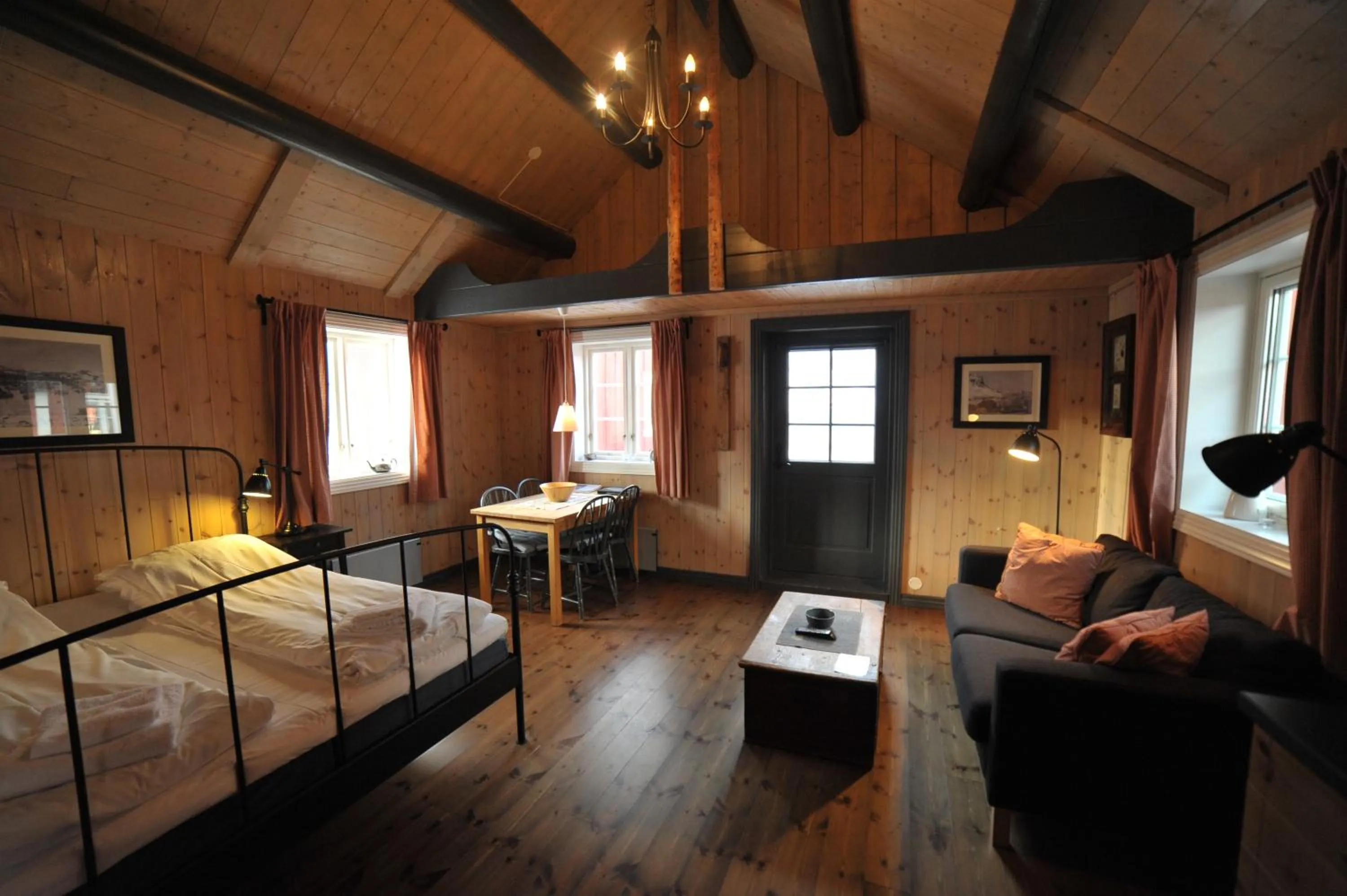 Living room, Bed in Reine Rorbuer - by Classic Norway Hotels