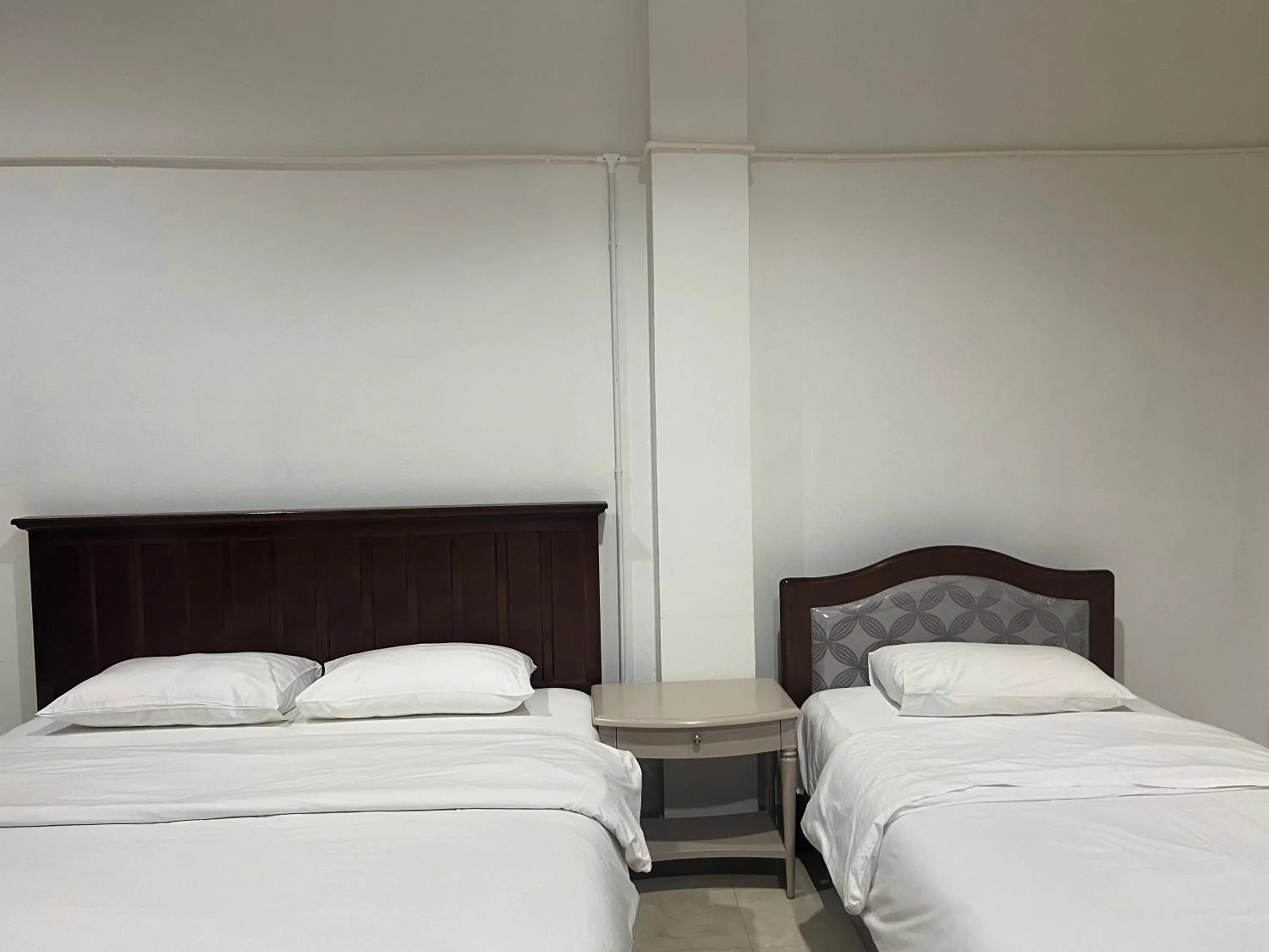 Bed in Mall Suites Hotel