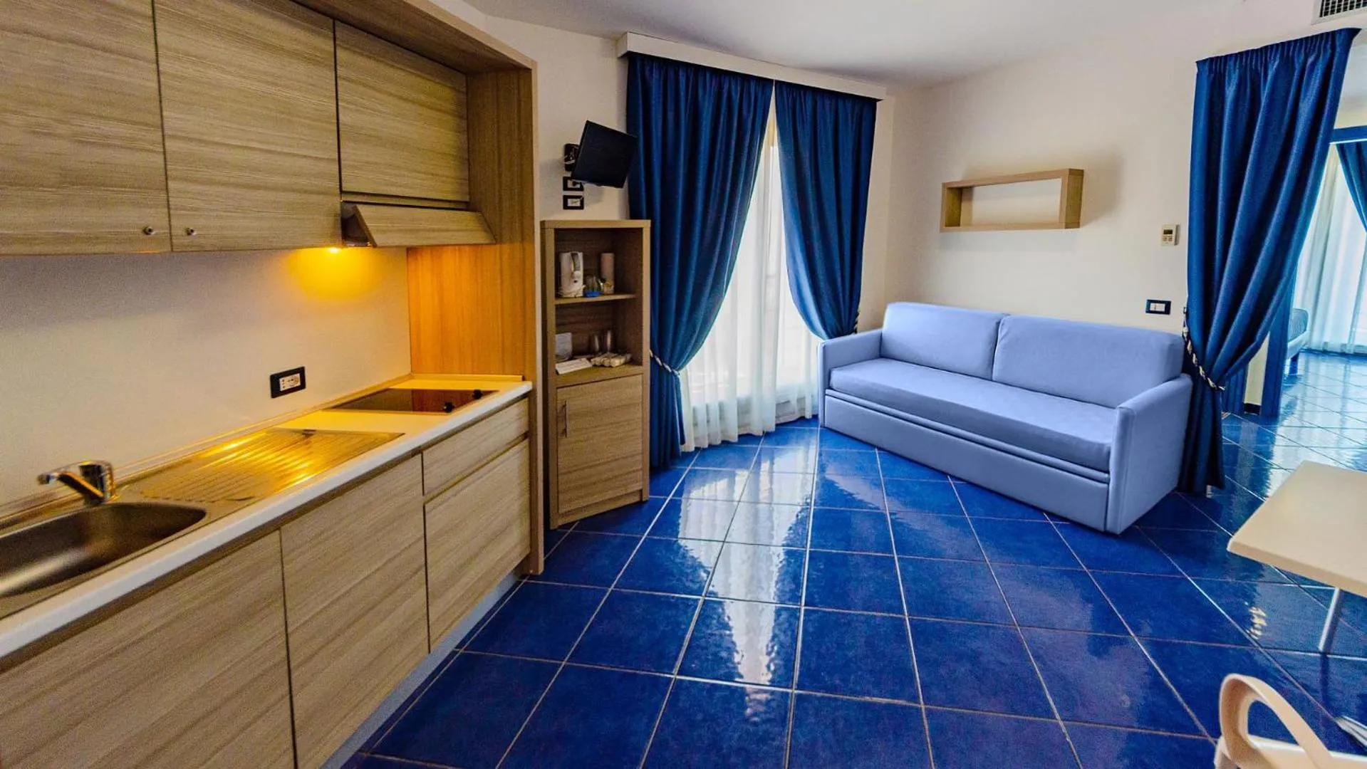 Kitchen or kitchenette, Bed in Astro Suite Hotel