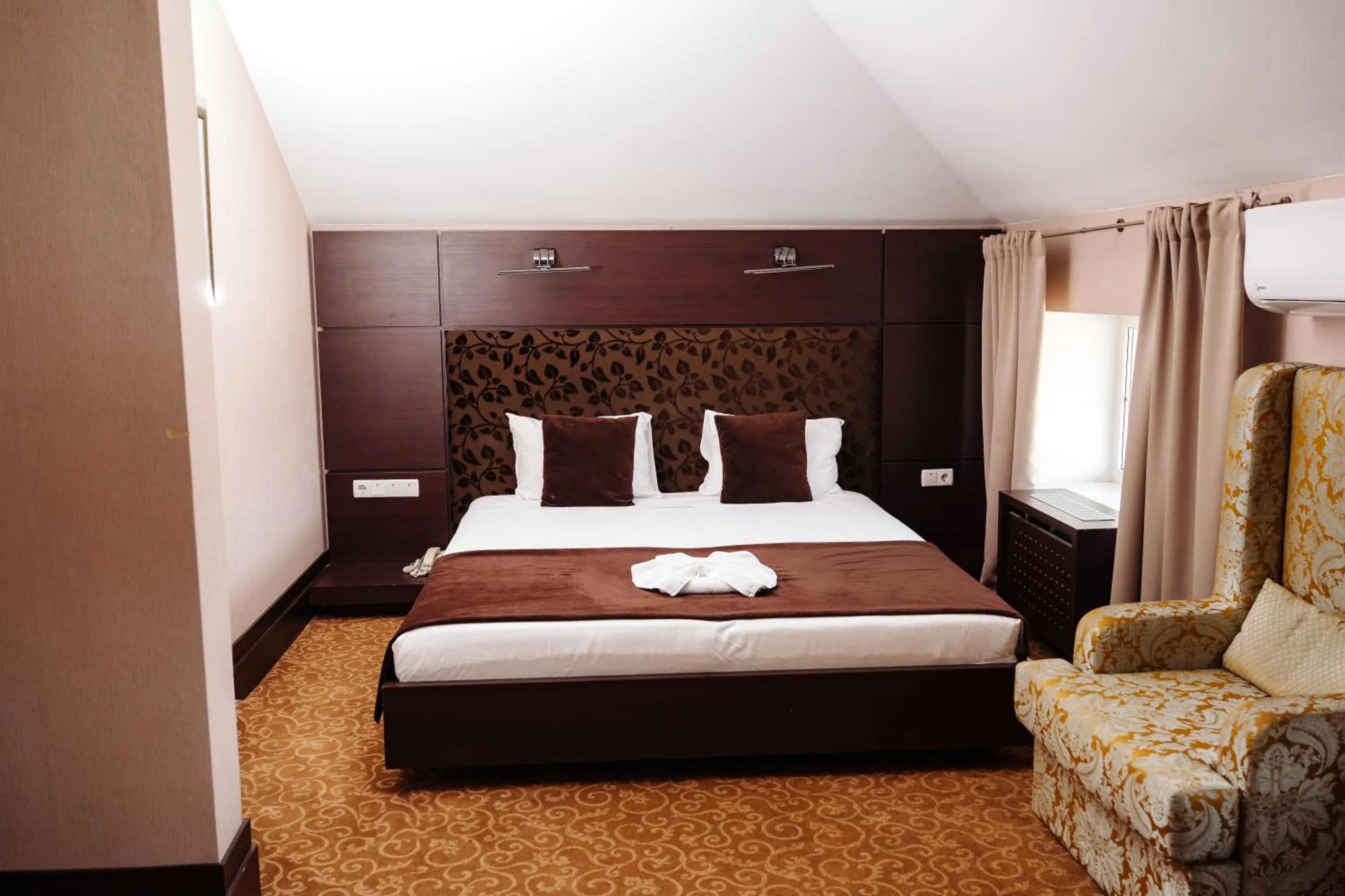 Bed in Maxim Pasha Hotel