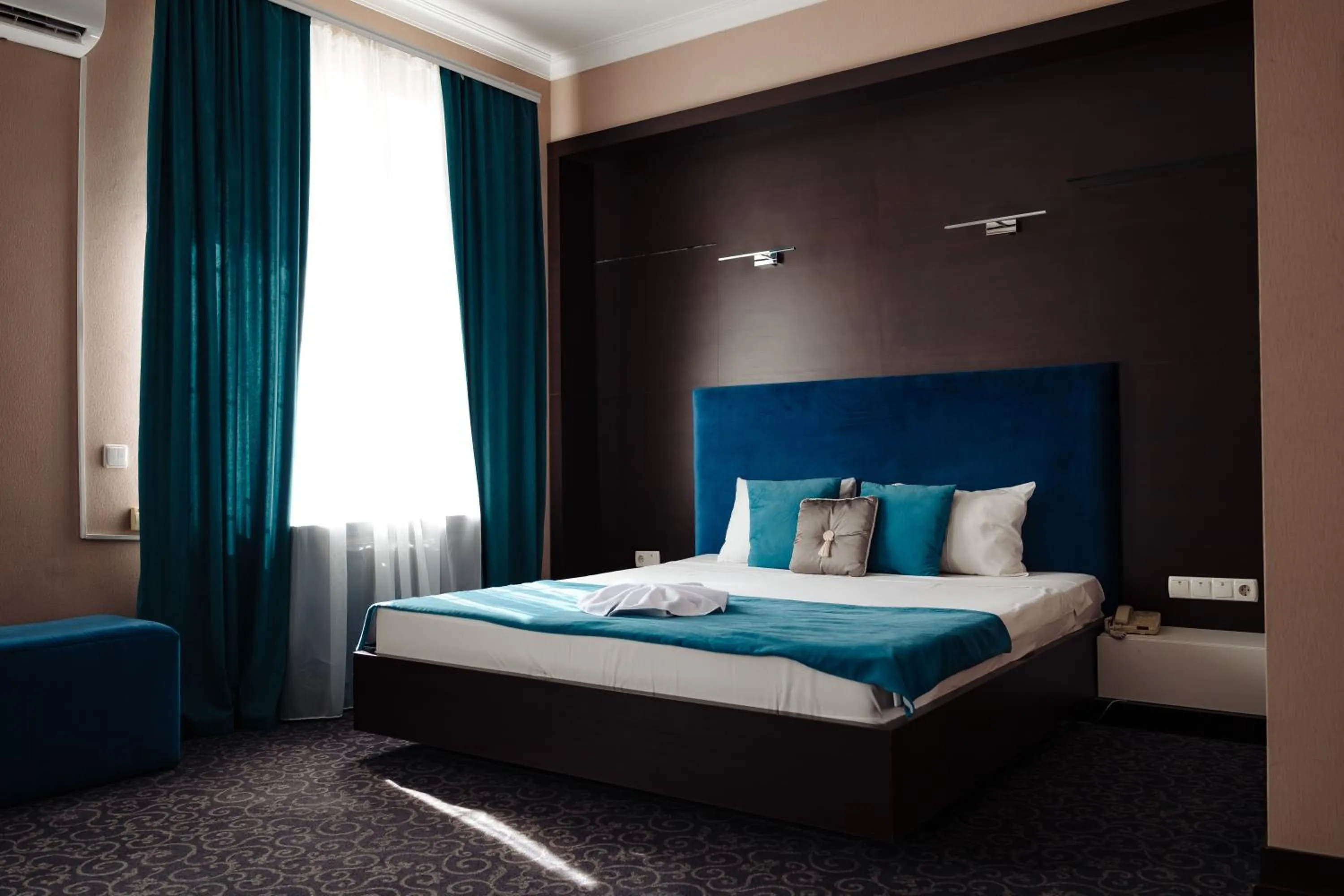 Bed in Maxim Pasha Hotel