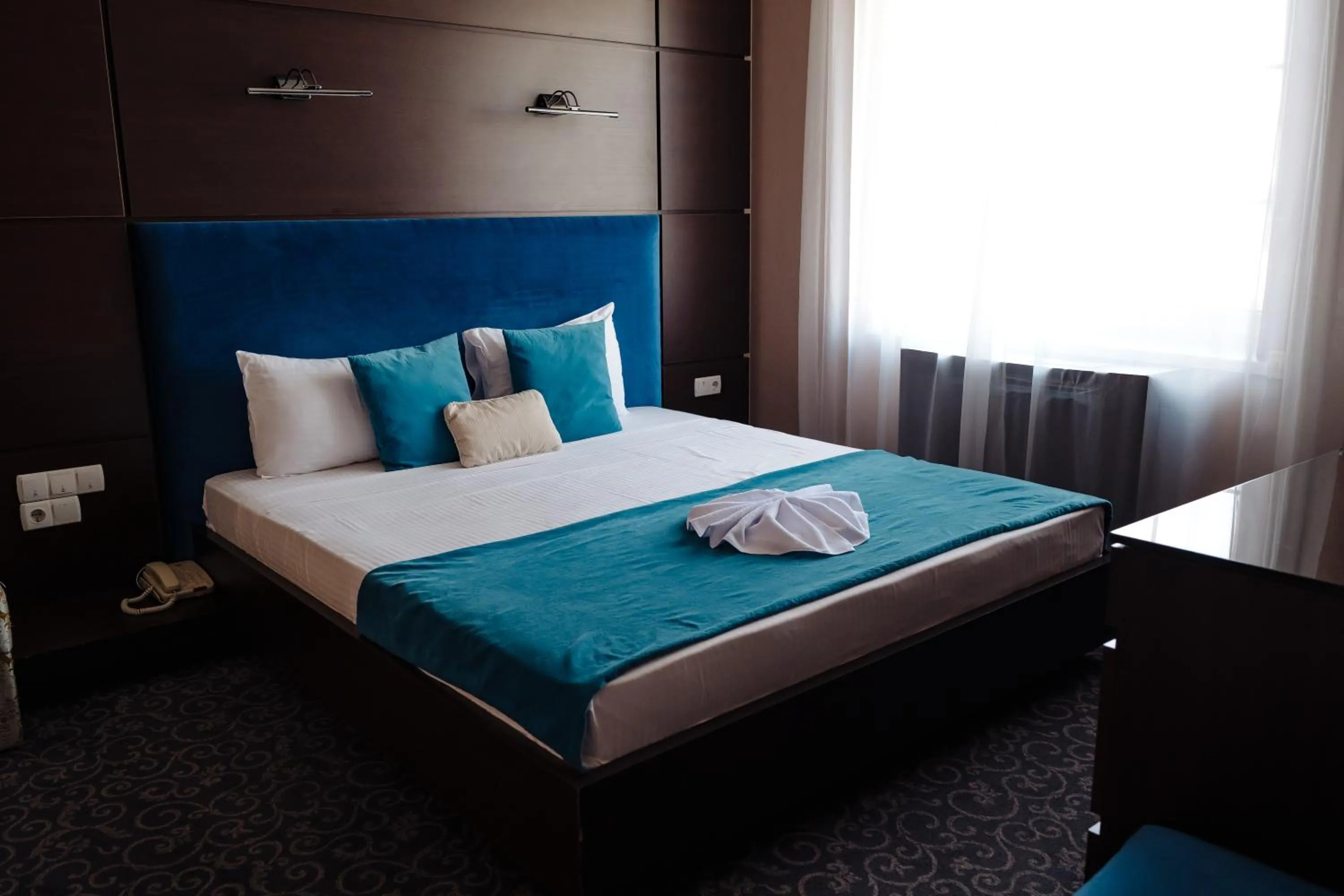 Bed in Maxim Pasha Hotel