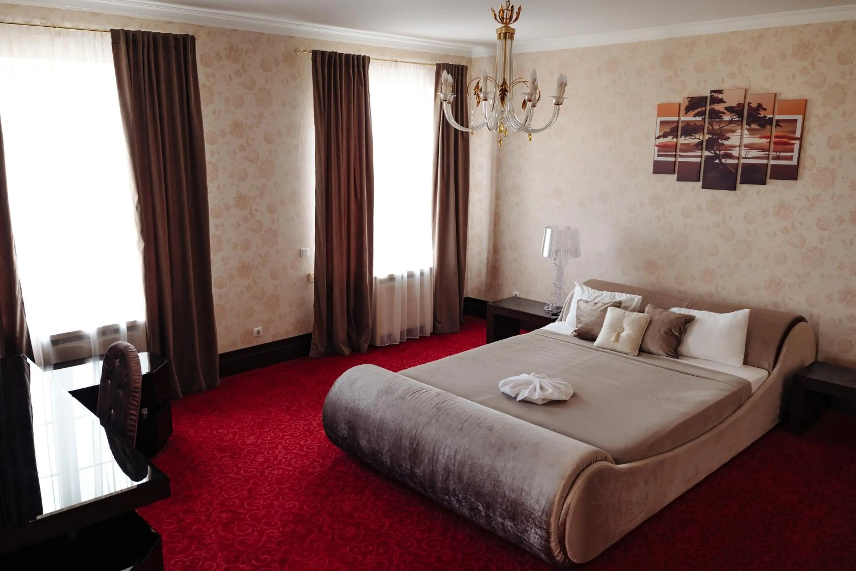 Bed in Maxim Pasha Hotel