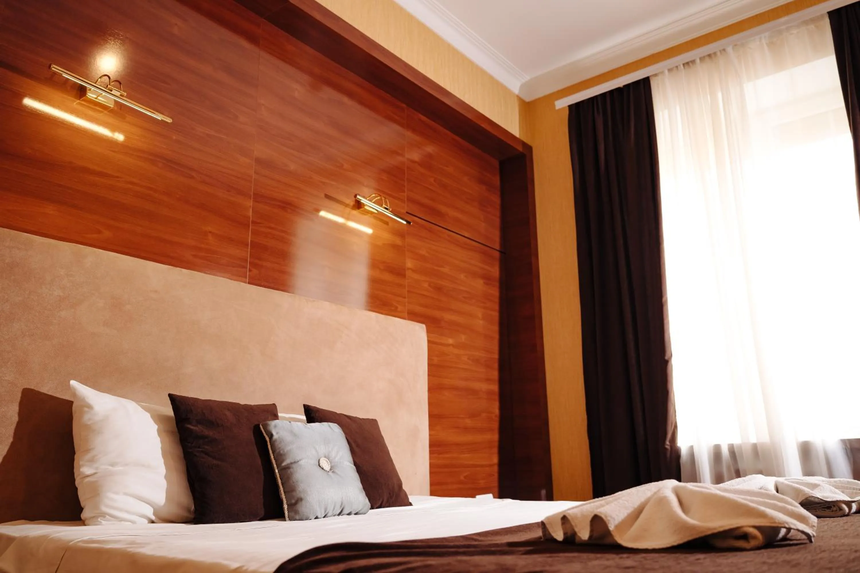 Bed in Maxim Pasha Hotel