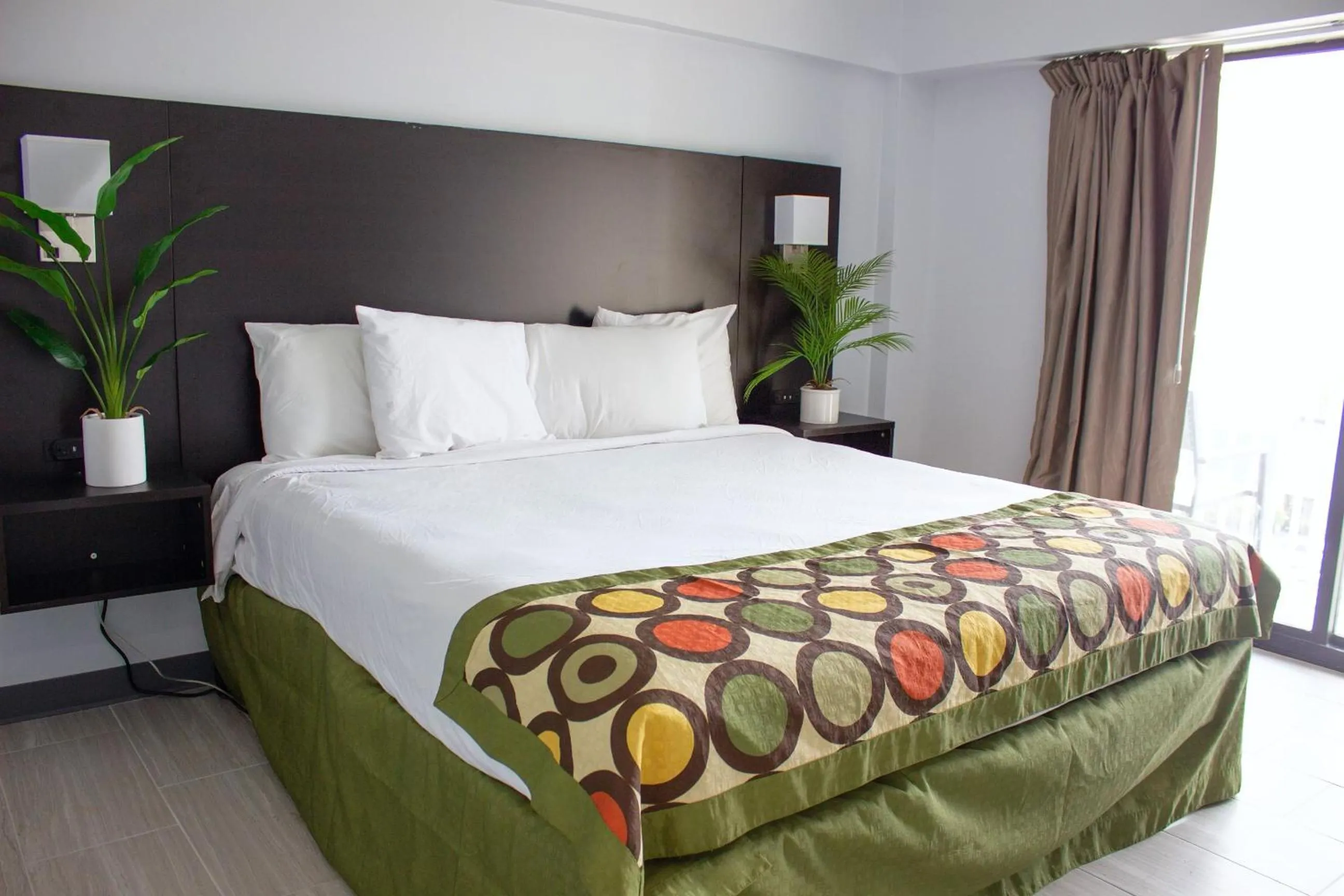 Bed in Sun & Sand Resort Oceanfront Suites