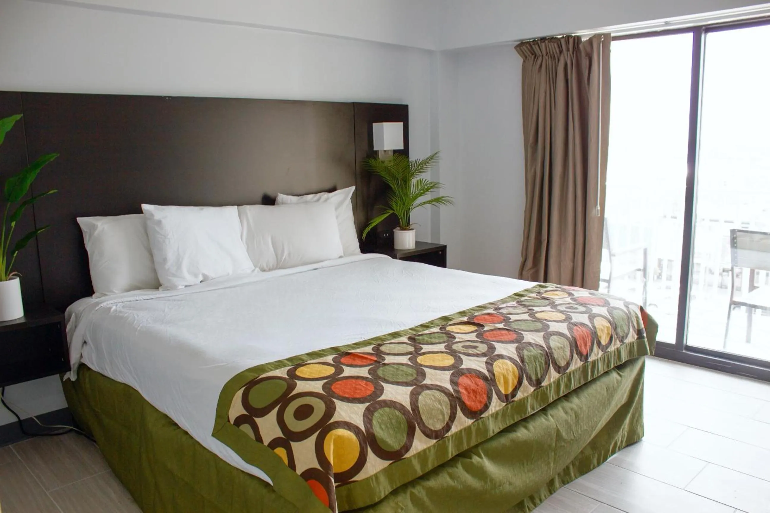 Bed in Sun & Sand Resort Oceanfront Suites