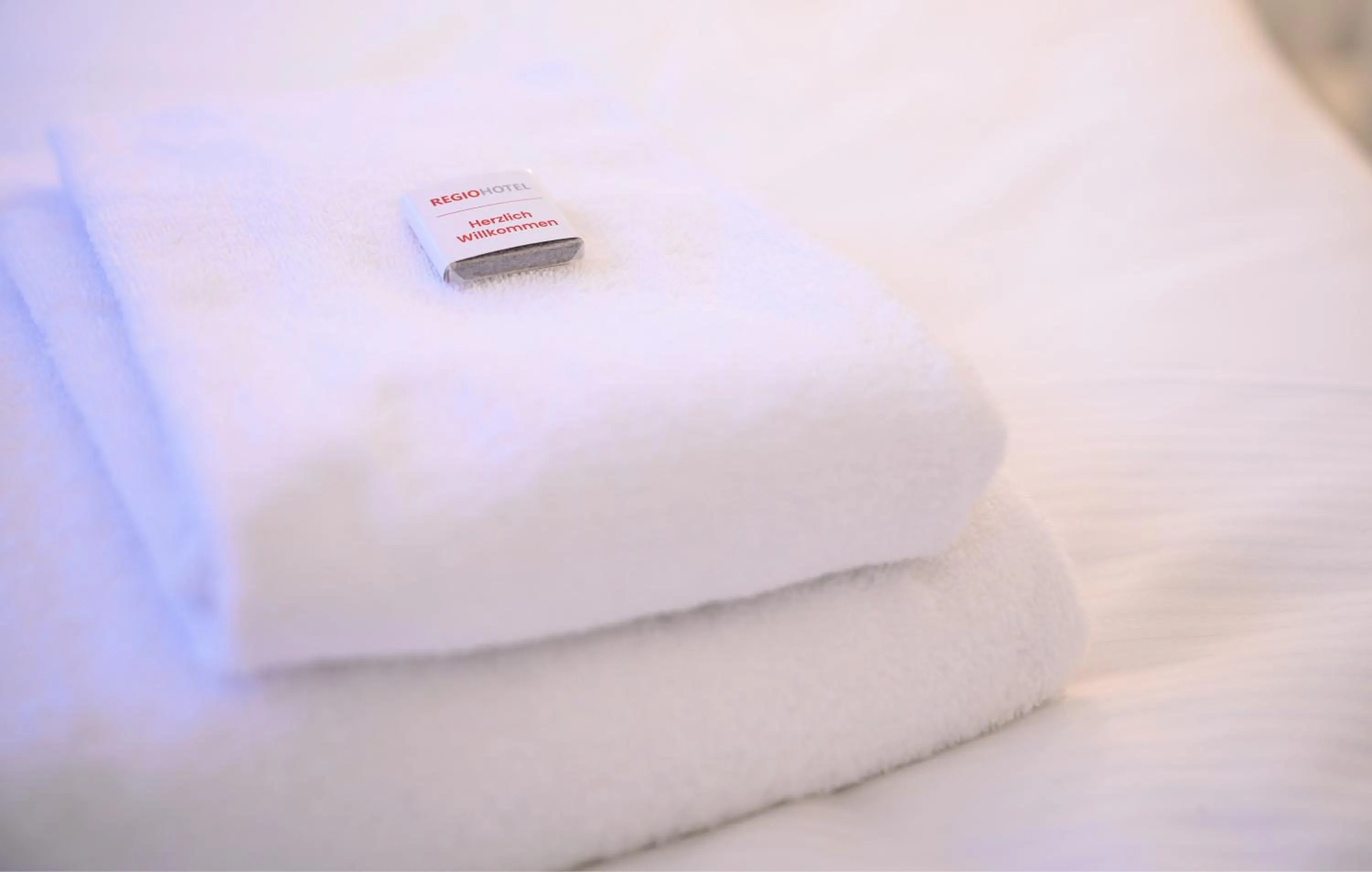 towels, Bed in REGIOHOTEL Halle Leipzig Airport