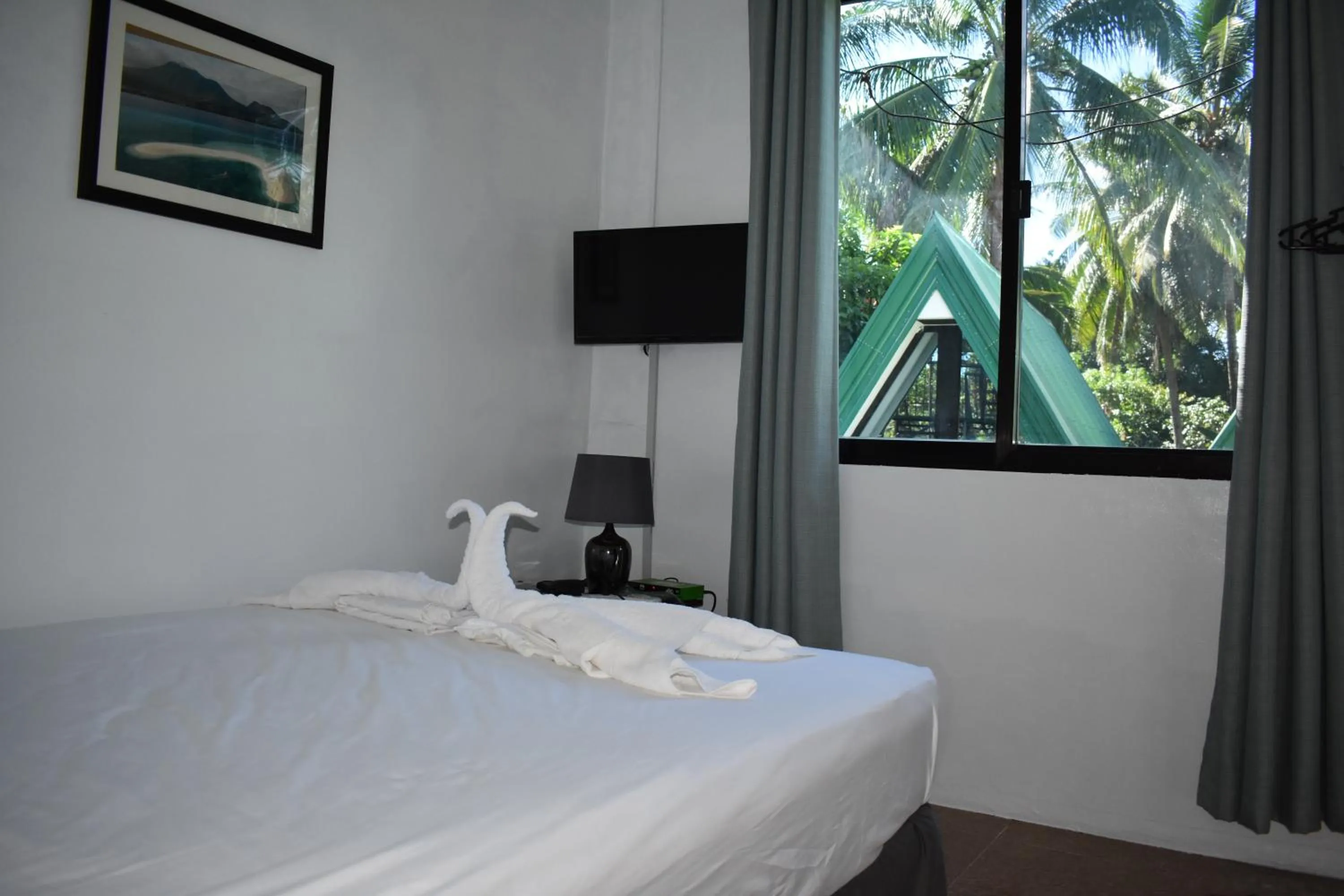 Bed in Seaside traveler's Inn by Camiguin Island Home