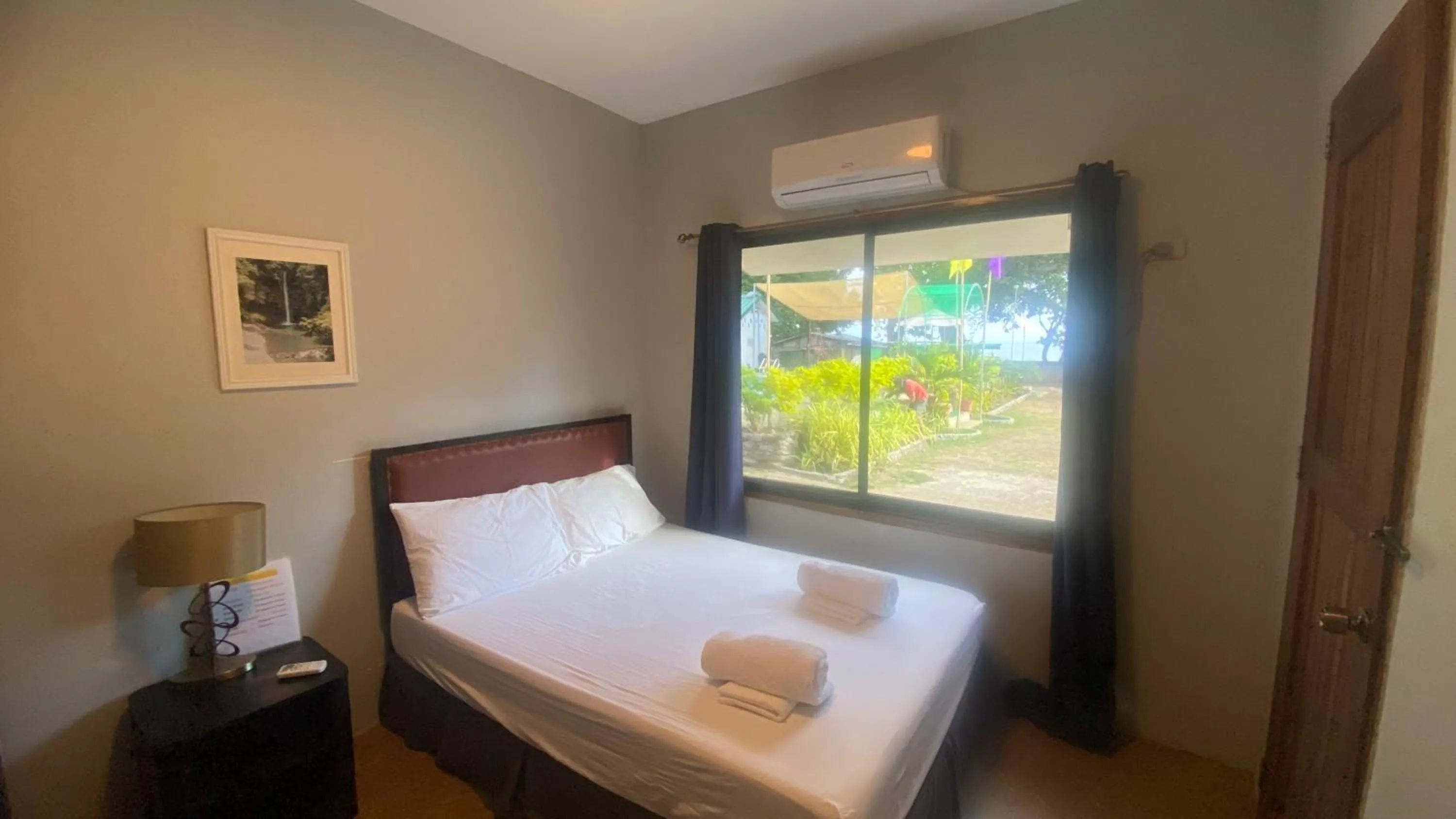 Bedroom, Bed in Seaside traveler's Inn by Camiguin Island Home