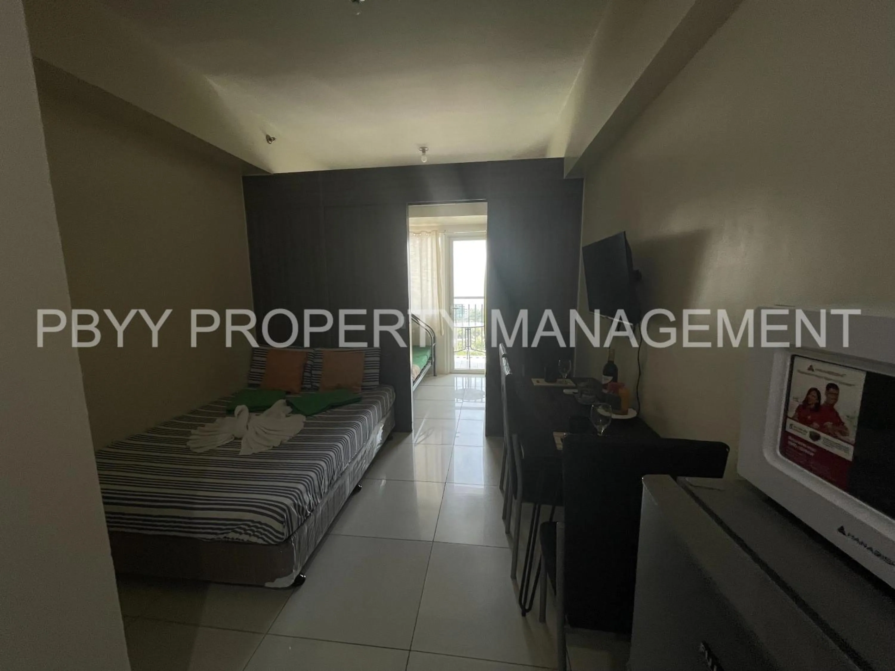 Bed in Green Residences Stays by PBYY