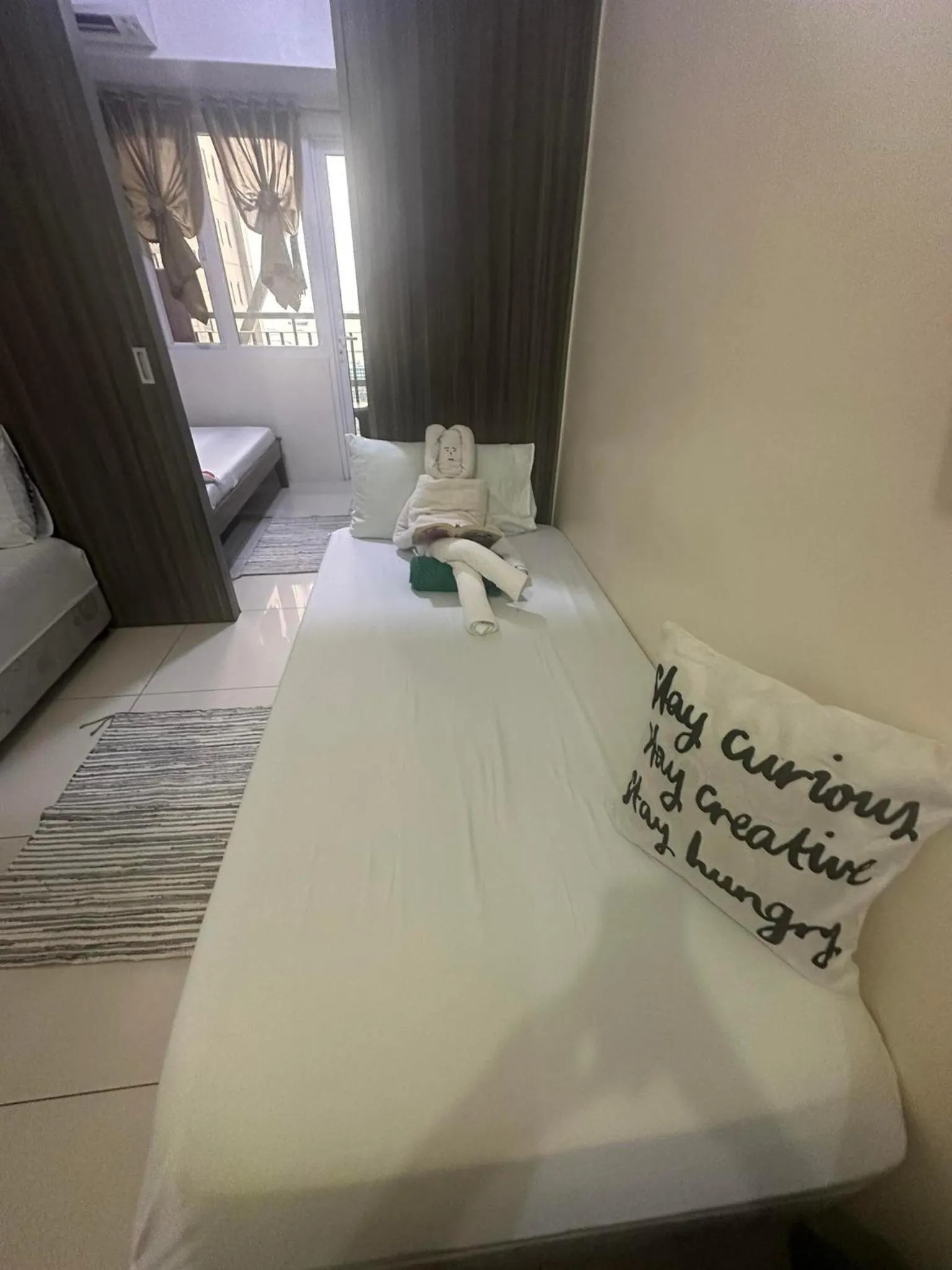 Bed in Green Residences Stays by PBYY