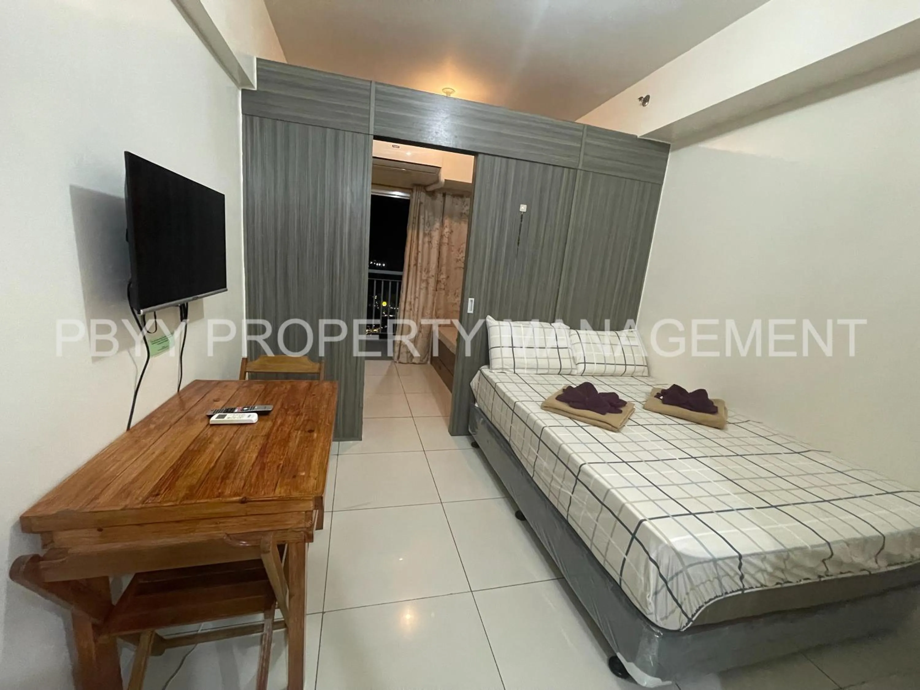 Bed in Green Residences Stays by PBYY