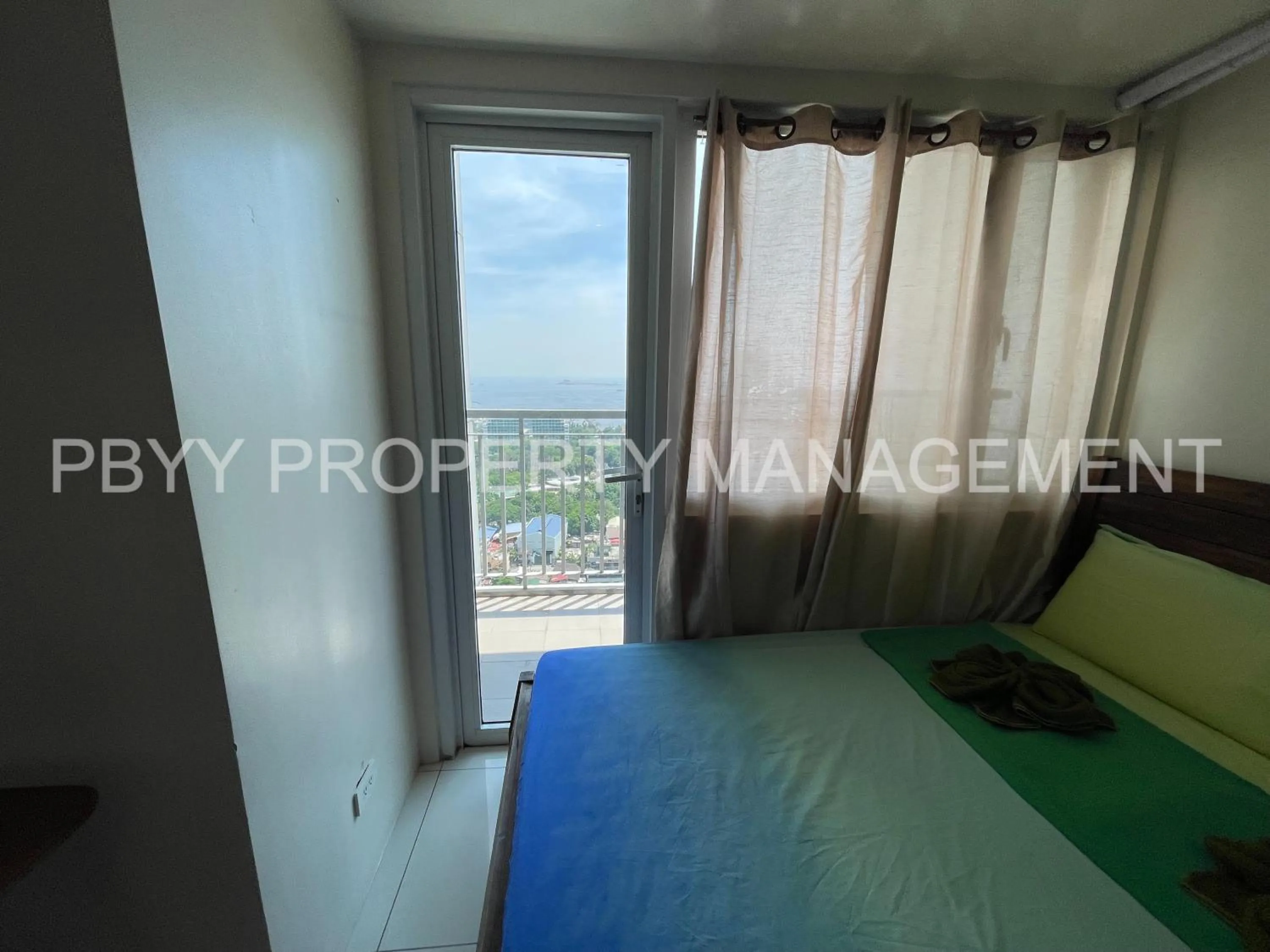 Bedroom in Green Residences Stays by PBYY