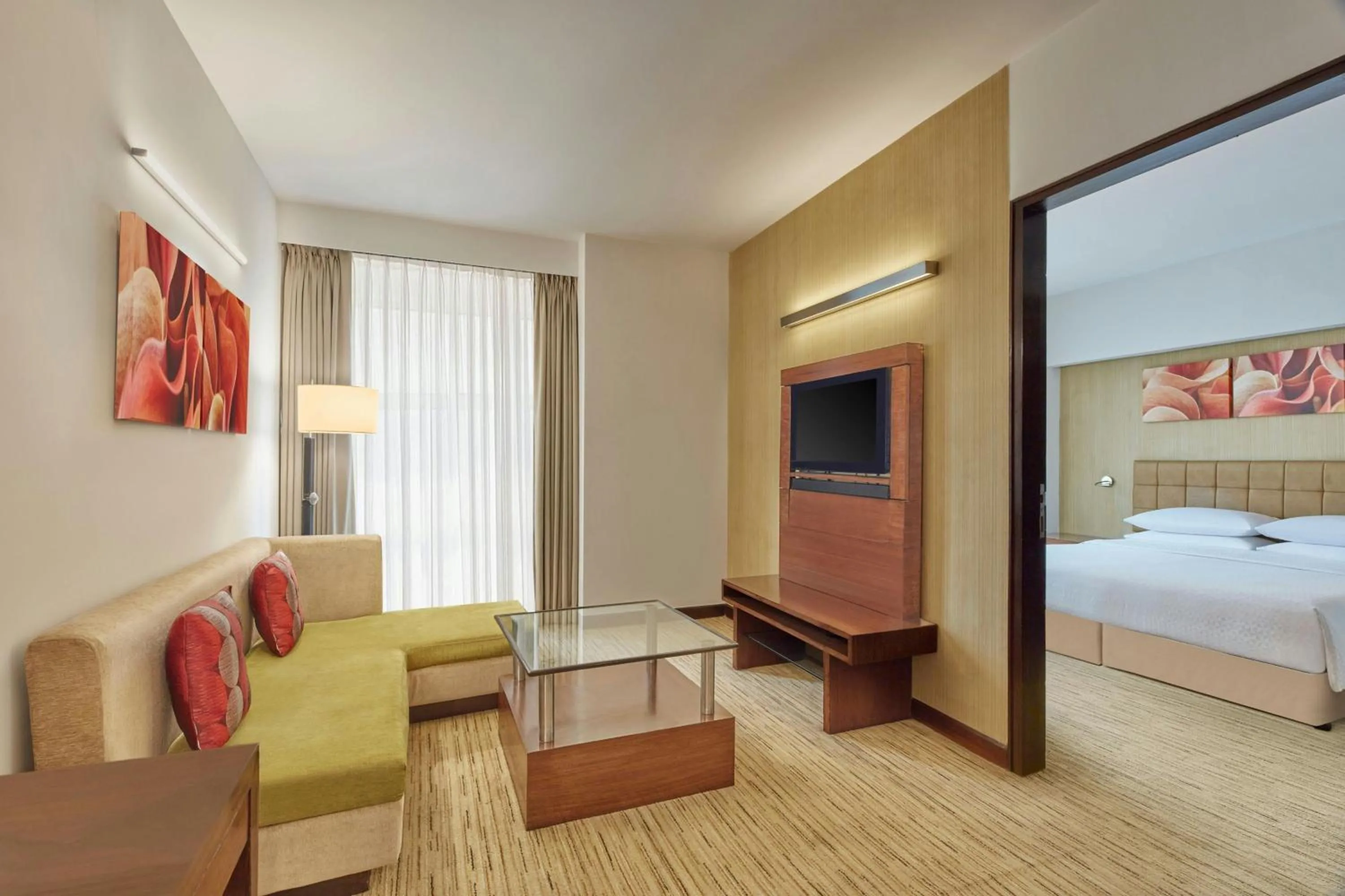 Living room, Bed in Four Points by Sheraton Hotel and Serviced Apartments Pune