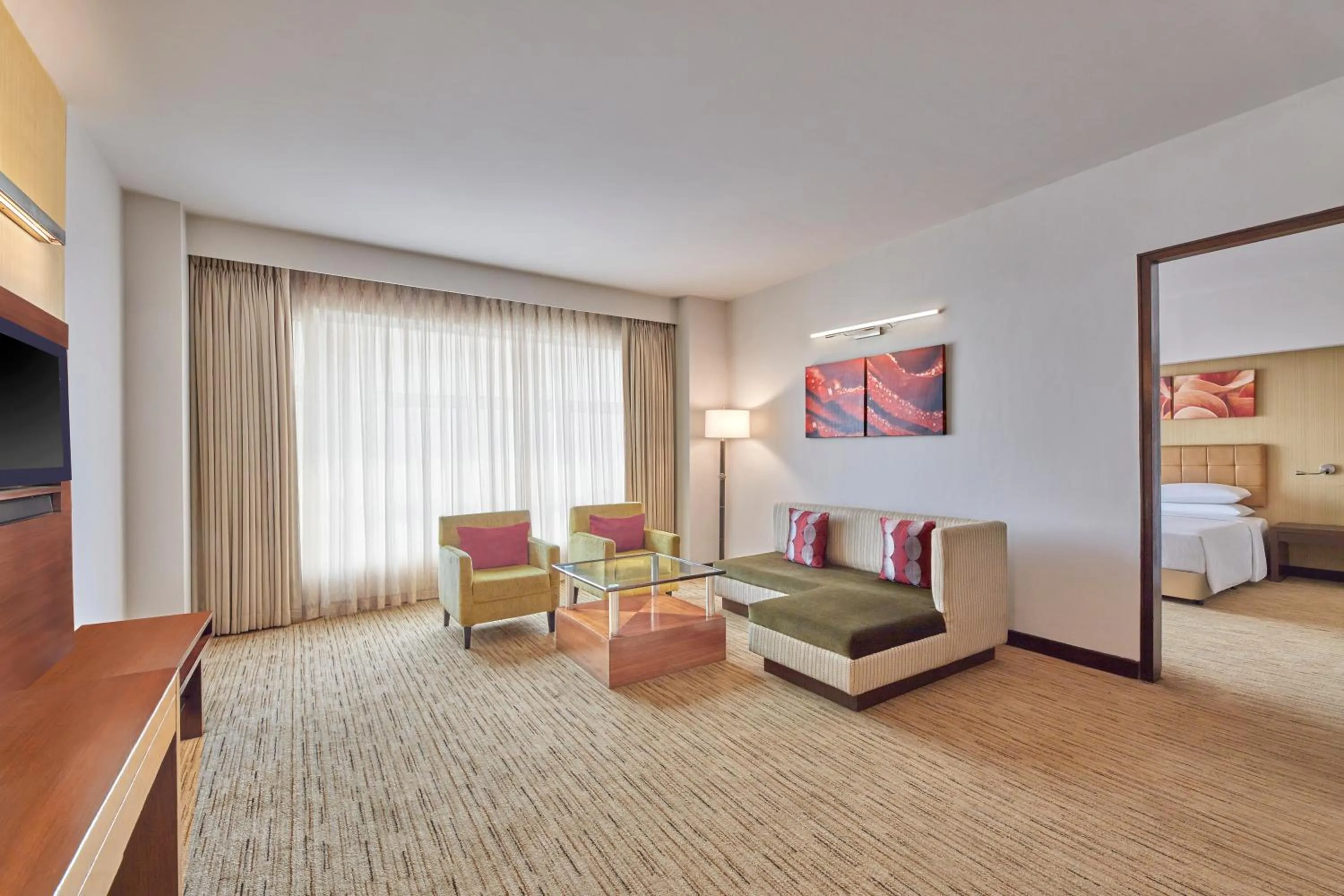 Living room, Bed in Four Points by Sheraton Hotel and Serviced Apartments Pune