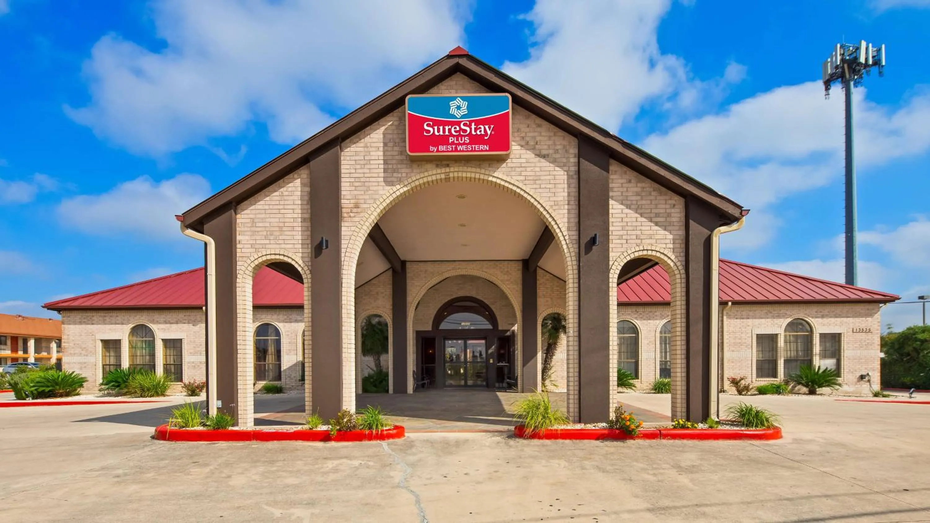 Property building in SureStay Plus by Best Western San Antonio Fiesta Inn