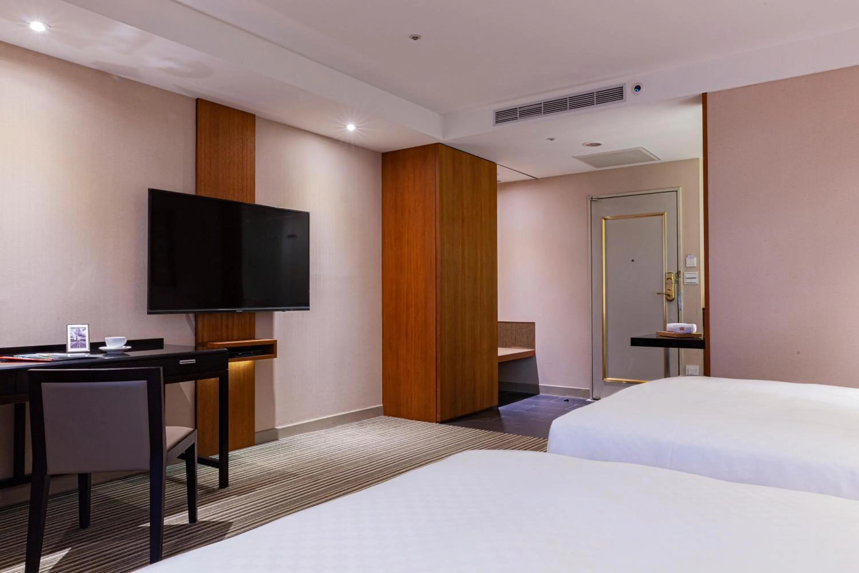 Bed in Pacific Business Hotel