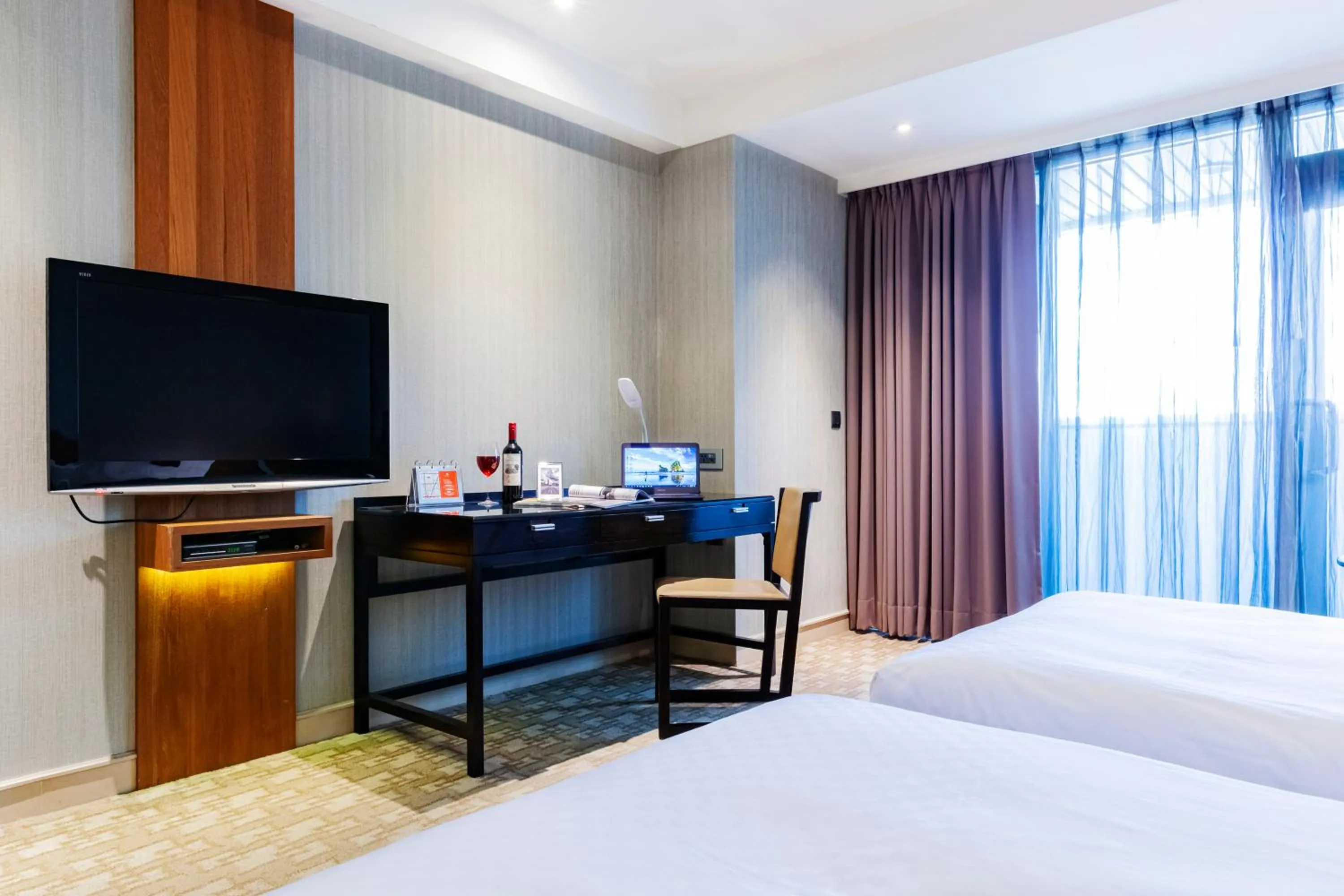 Bed in Pacific Business Hotel