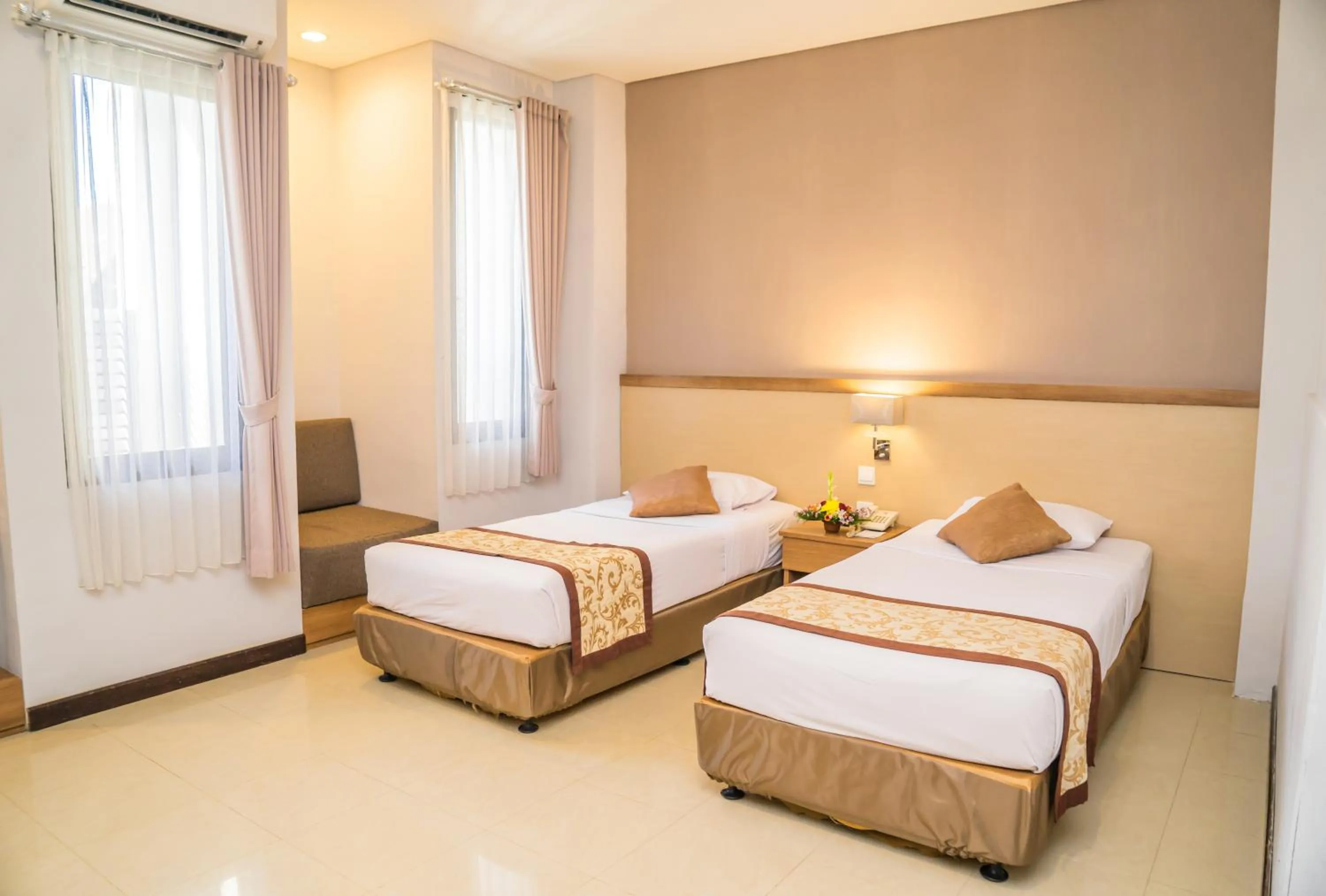 Bed in Hotel Puri Ayu