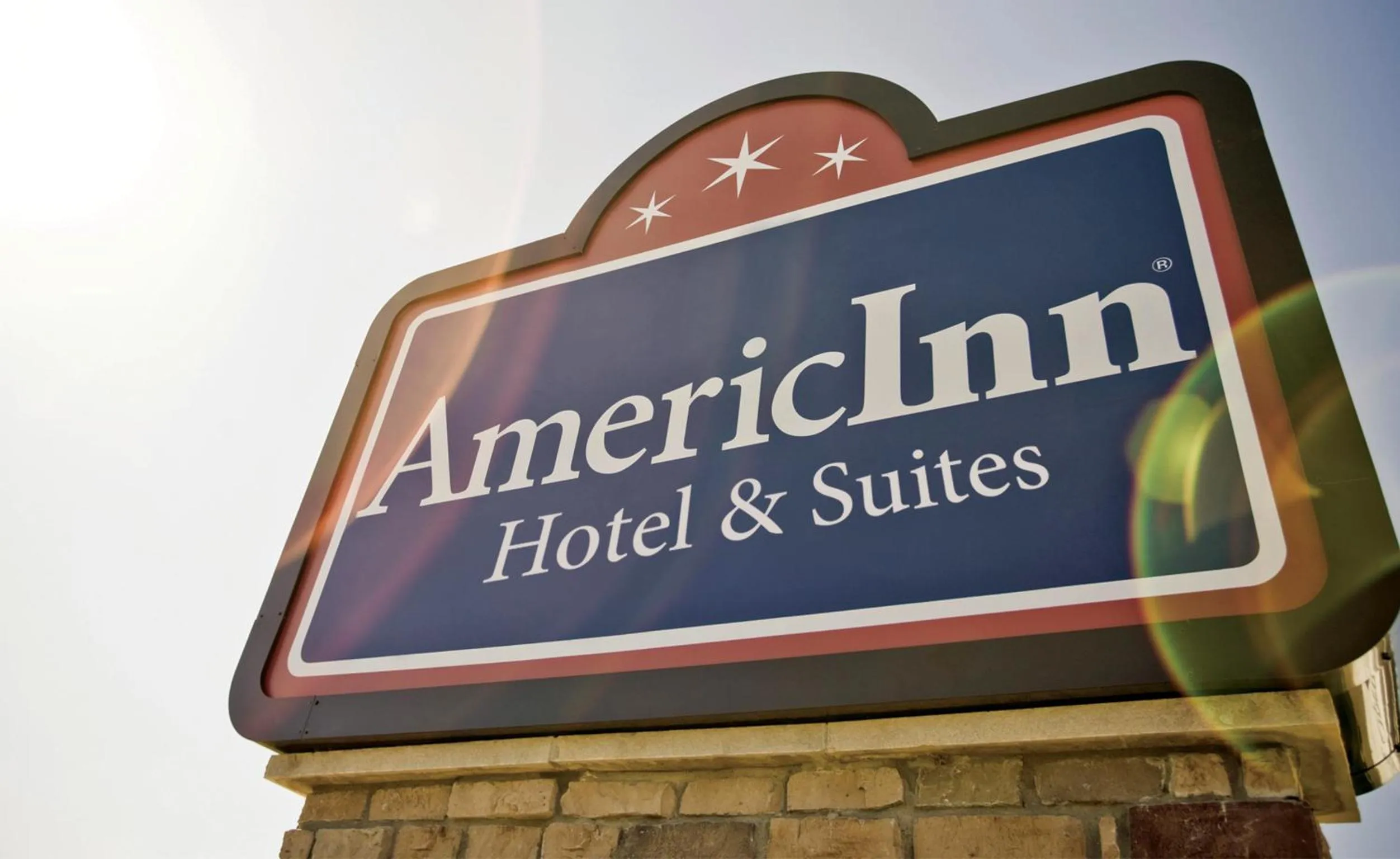 Property logo or sign in AmericInn by Wyndham Grimes