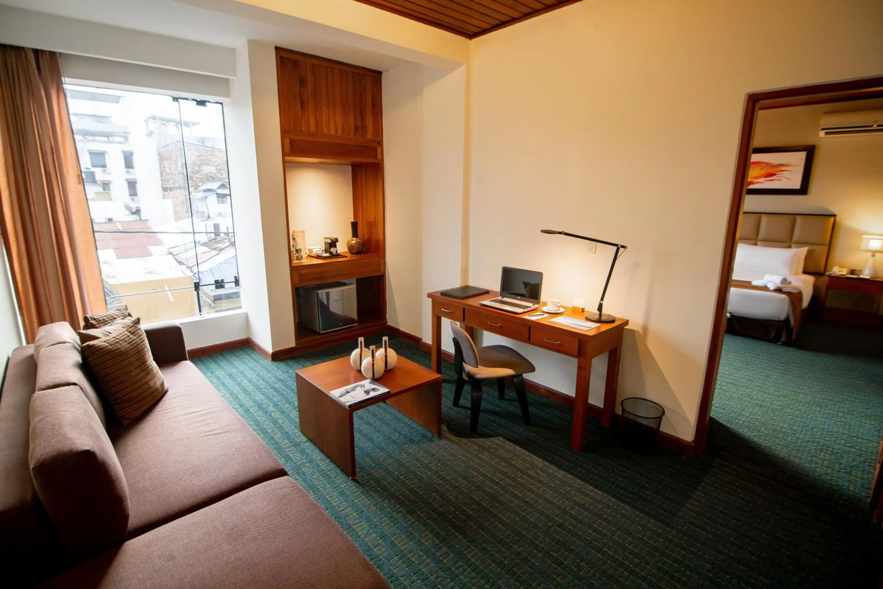 Seating area, Bed in El Dorado Classic Hotel