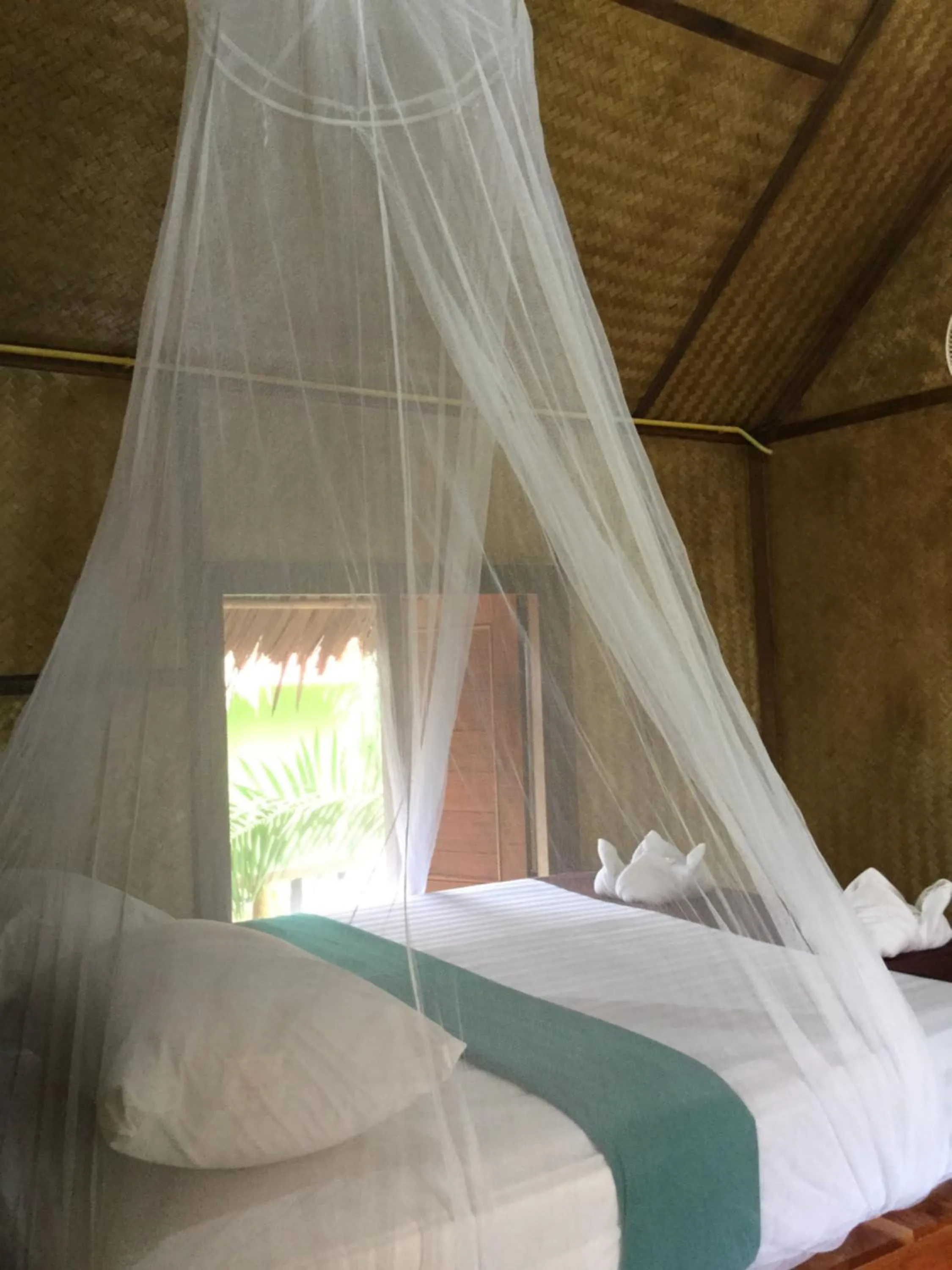 Photo of the whole room, Bed in Khaosok Bamboo Huts Resort