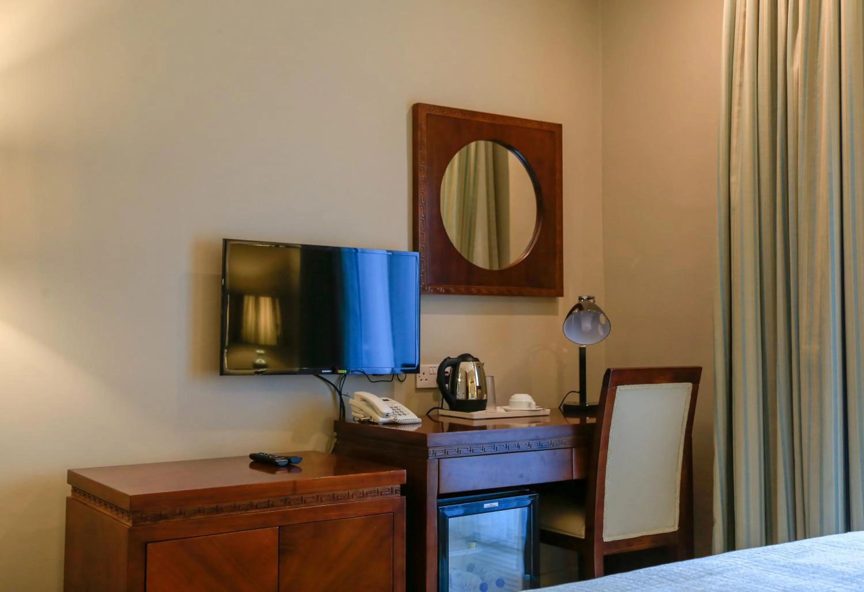 Communal lounge/ TV room, Bed in Muscat Inn Hotel