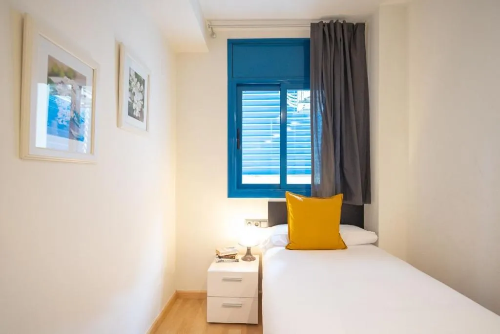 Bed in Lucas House Apartments by Sitges Group