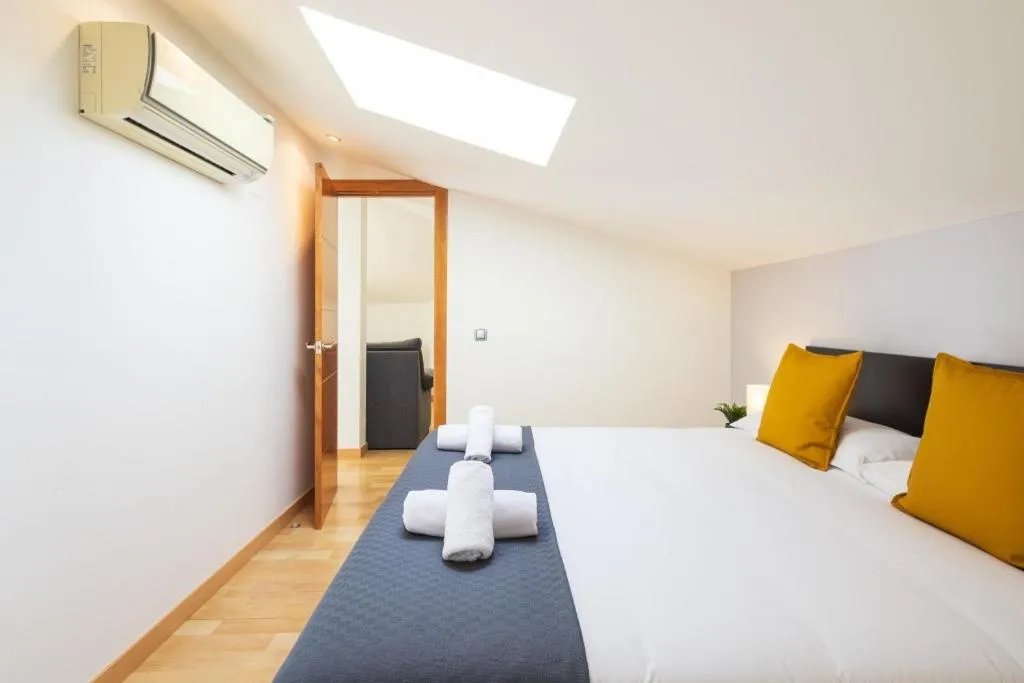 Bed in Lucas House Apartments by Sitges Group