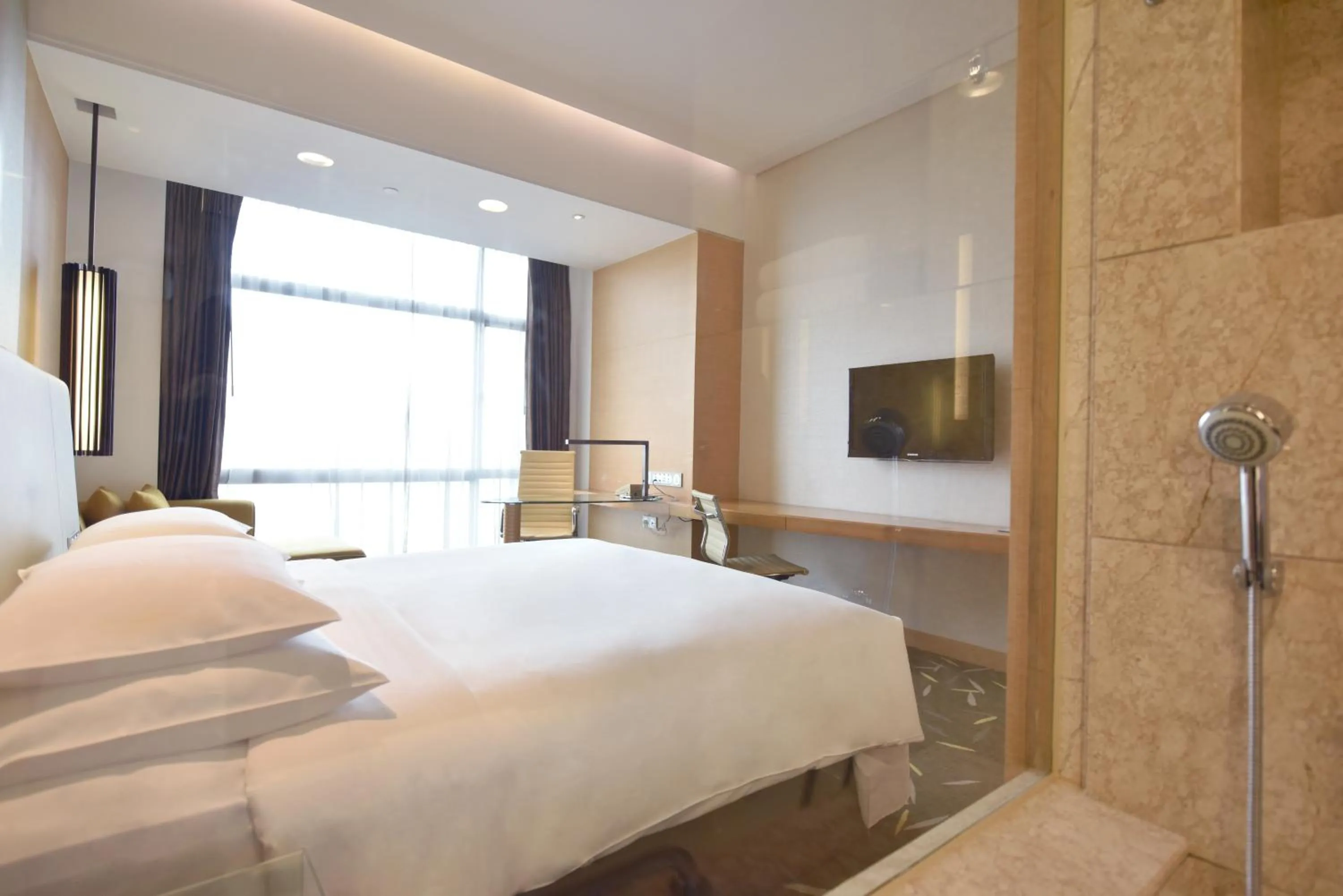 Bed in Crowne Plaza Zhongshan Wing On City by IHG