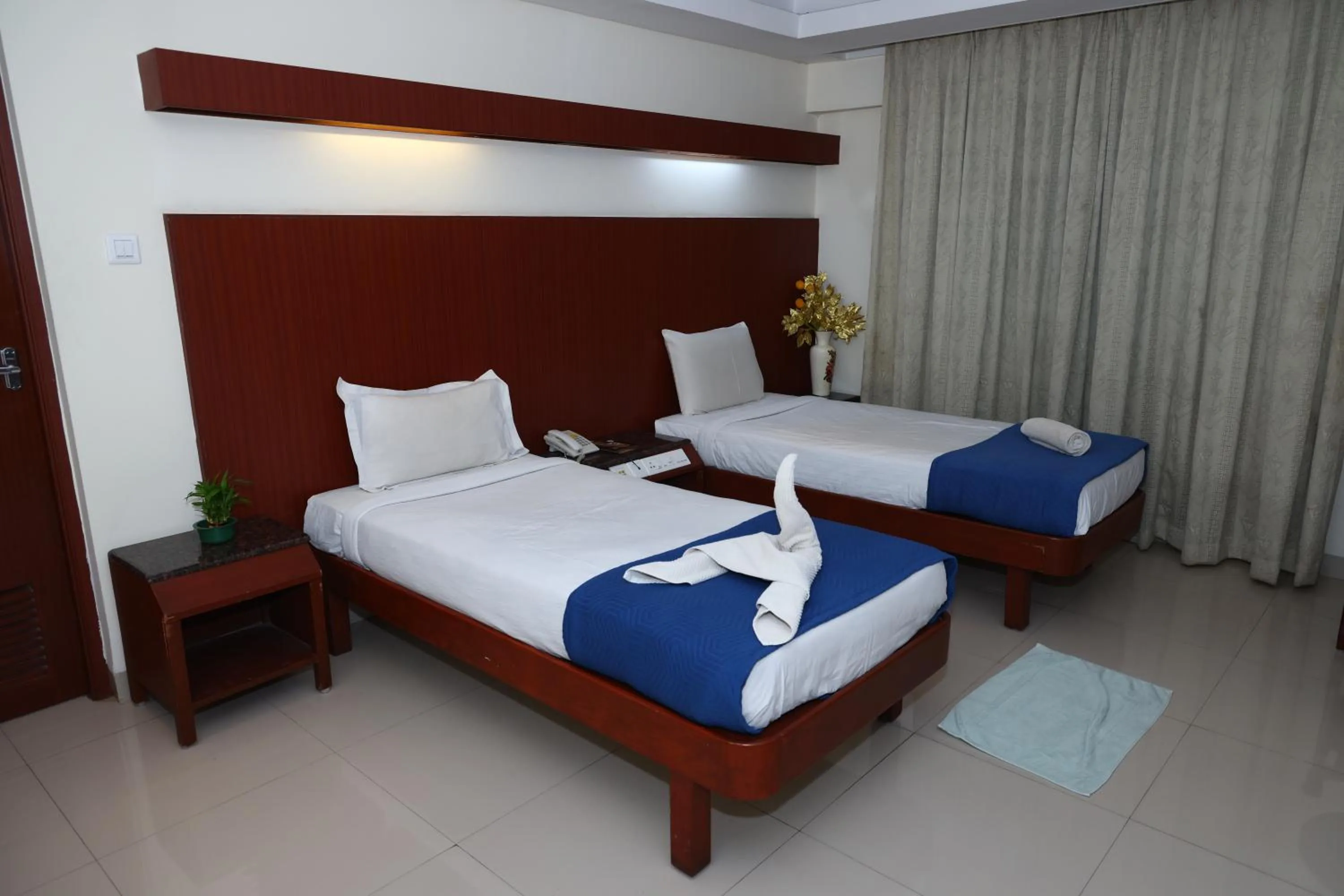 Bed in Dhanunjayas Luxury Hotel