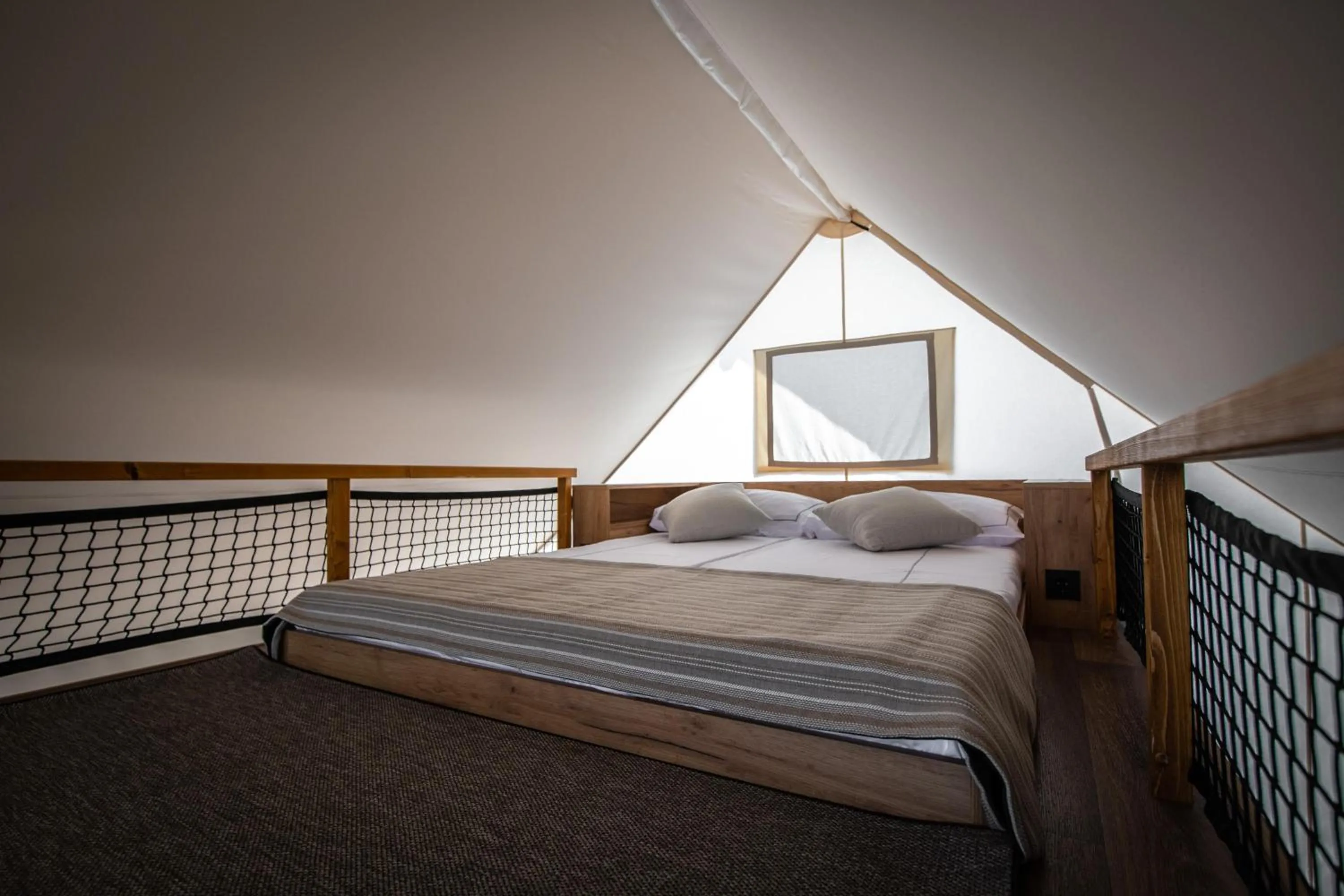 Bed in Arena One 99 Glamping