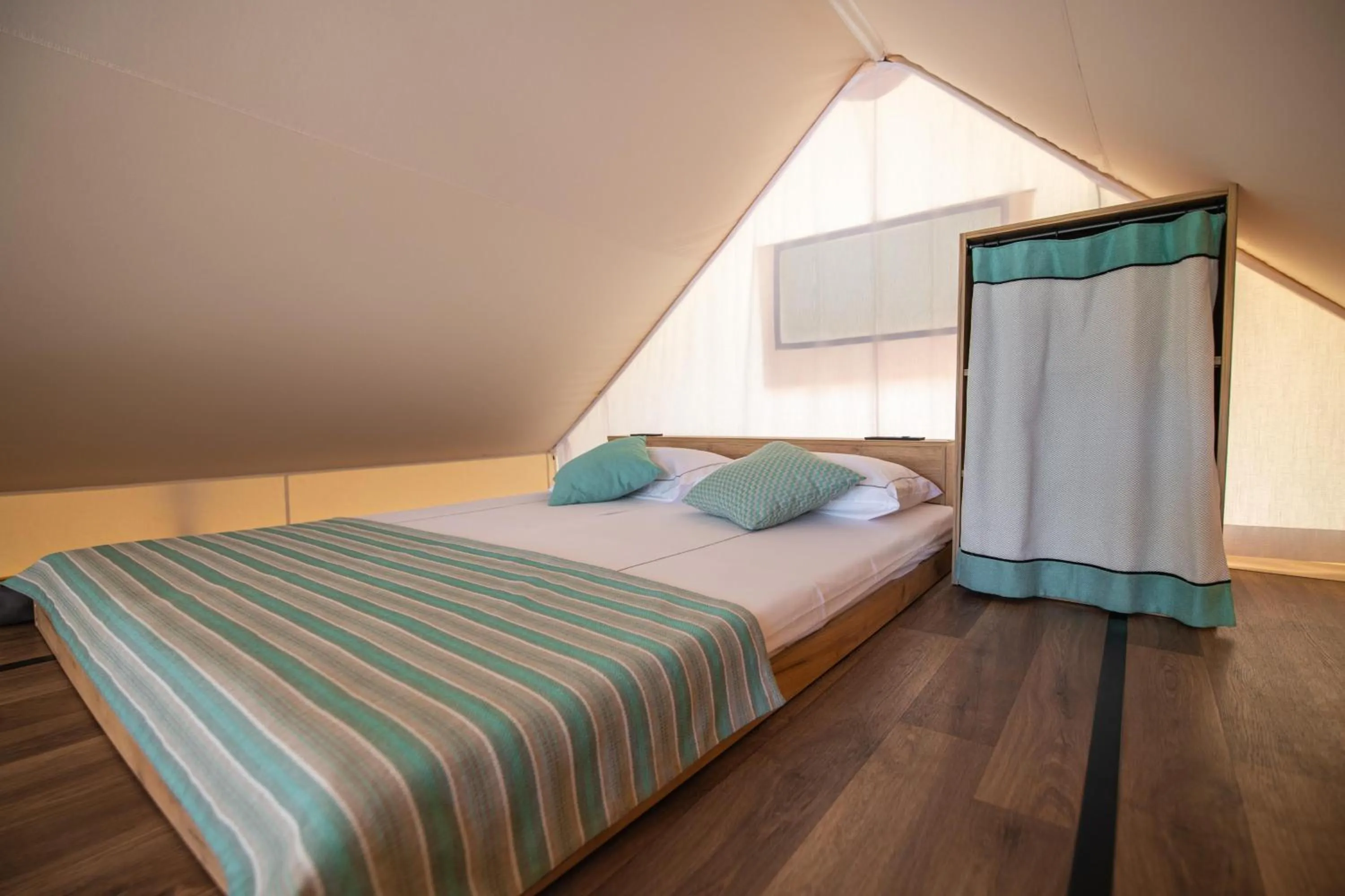 Bed in Arena One 99 Glamping