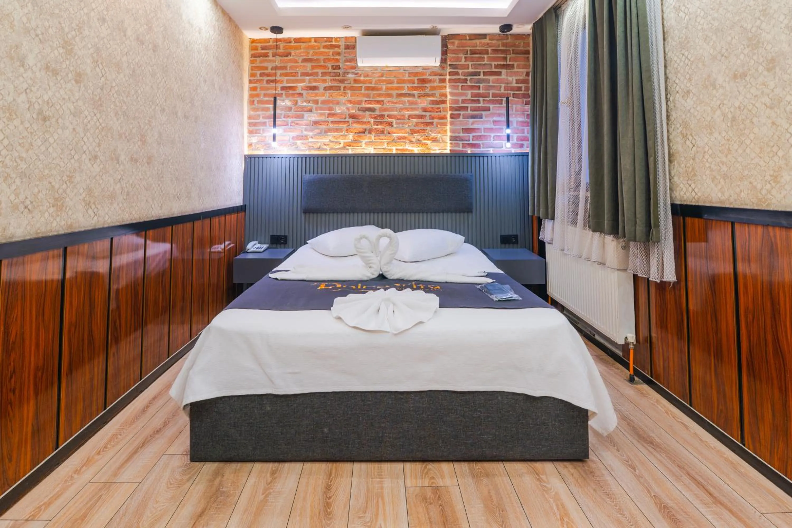 Bed in Dolce Vita Suite Hotel