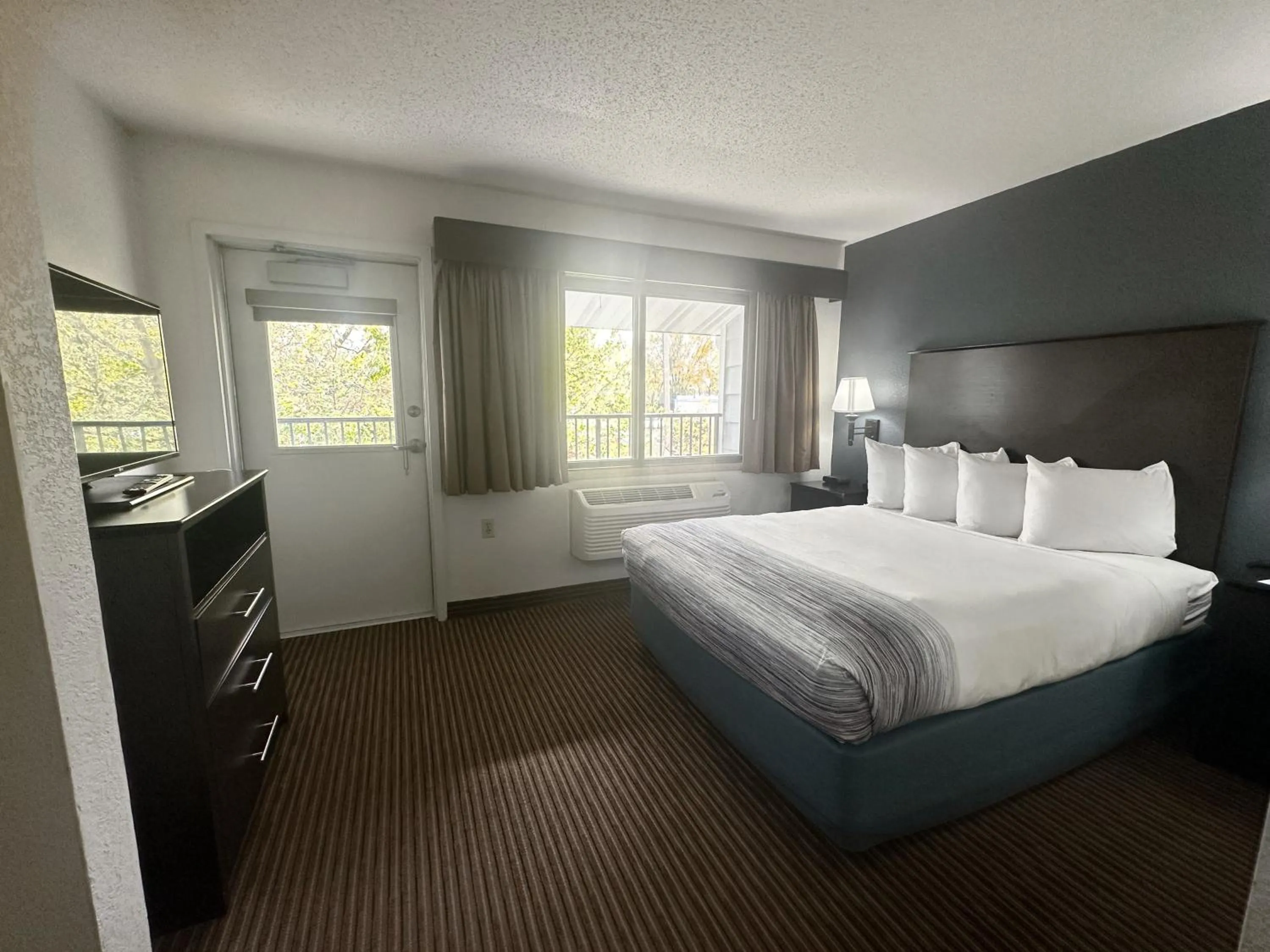 Bed in AmericInn by Wyndham Menominee
