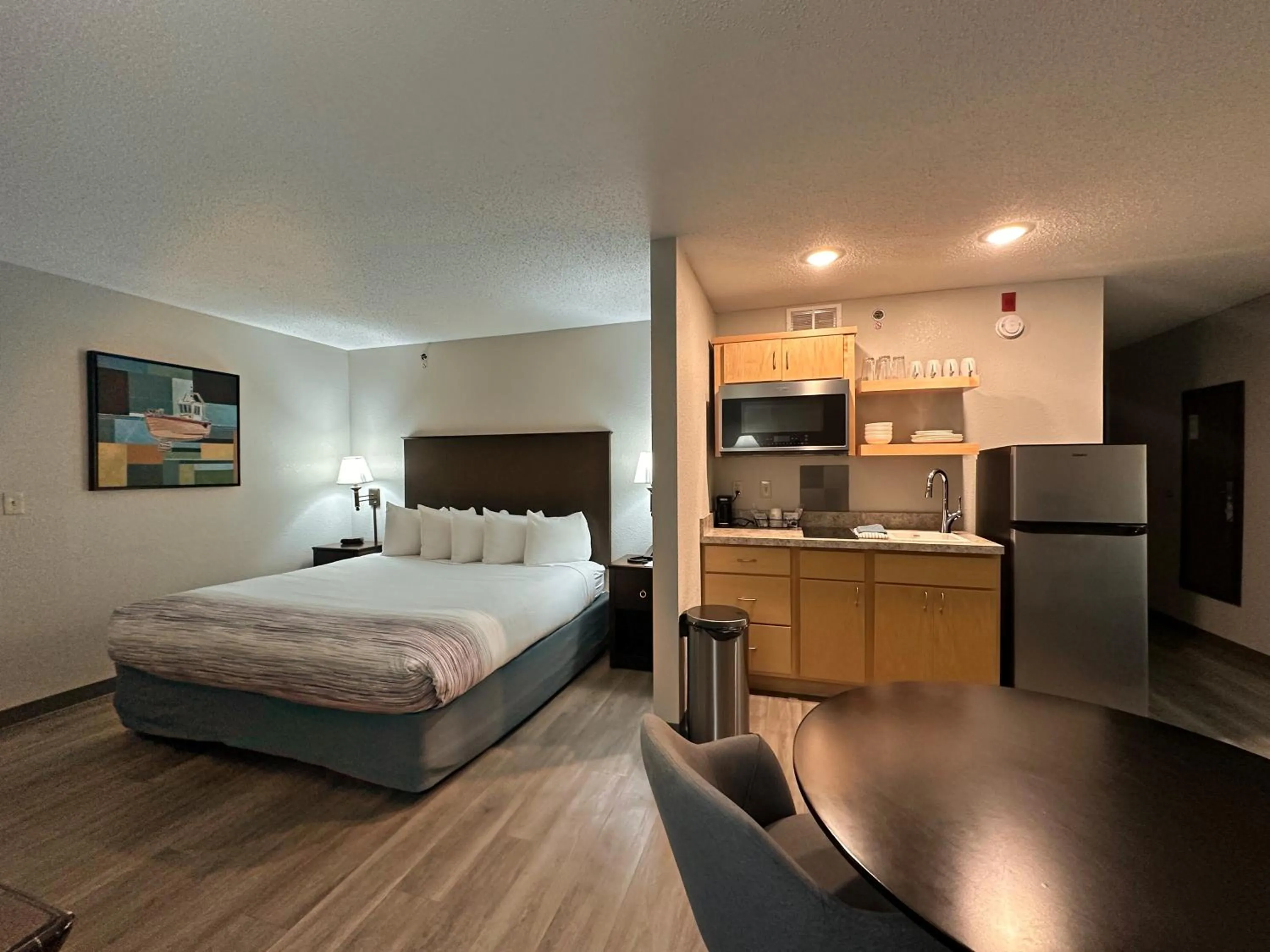 Bed in AmericInn by Wyndham Menominee