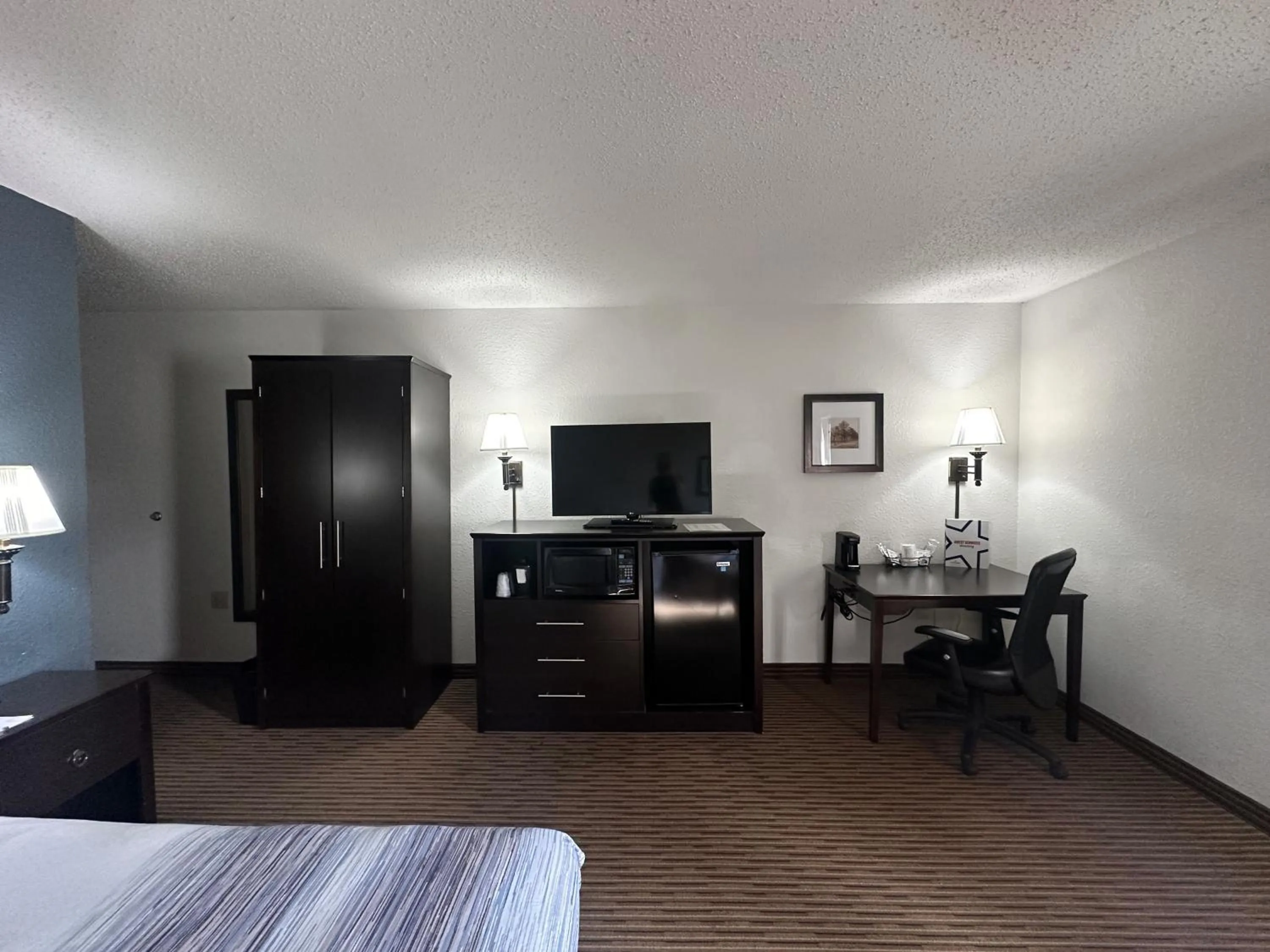 Bed in AmericInn by Wyndham Menominee