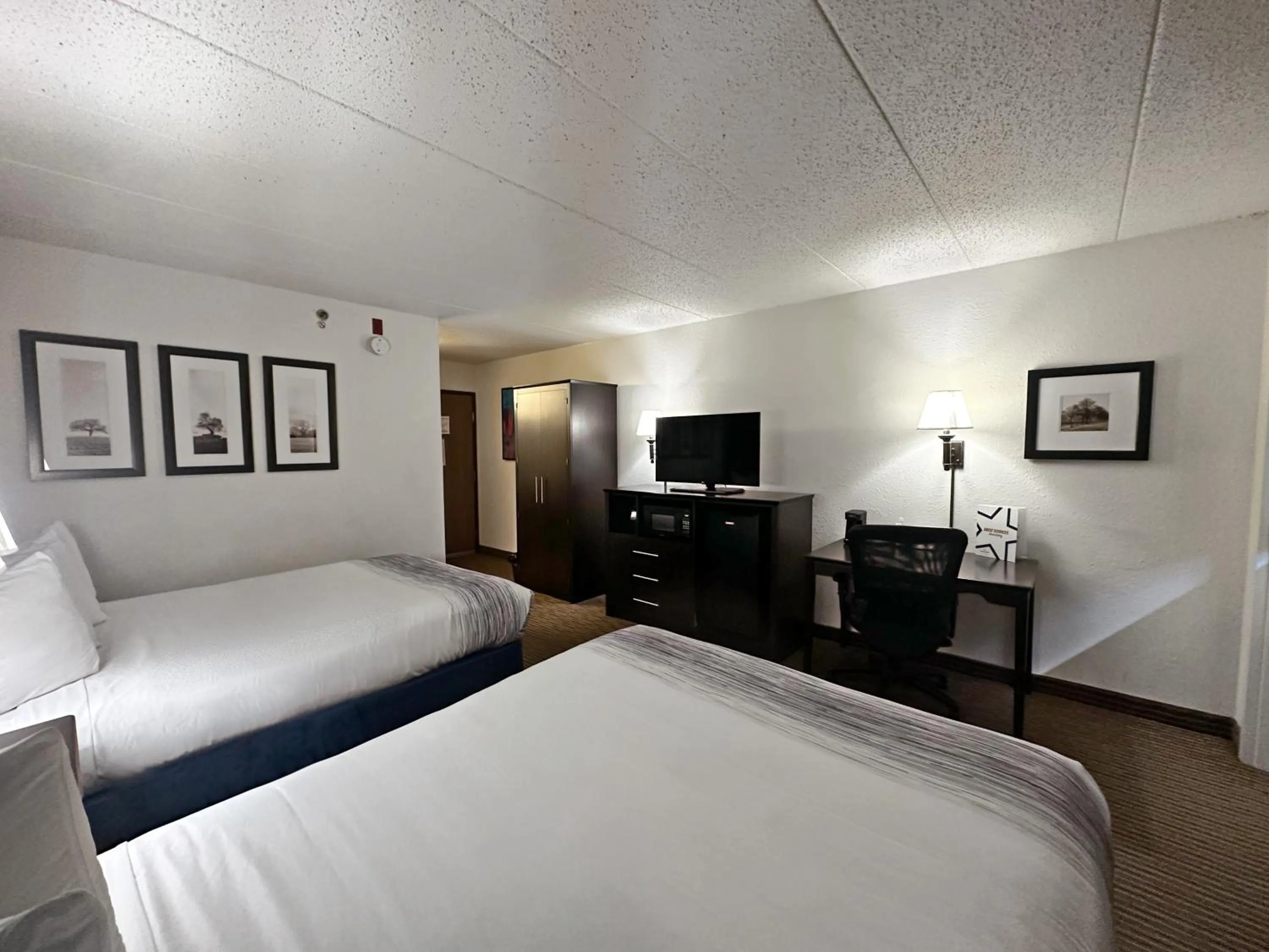 Bed in AmericInn by Wyndham Menominee