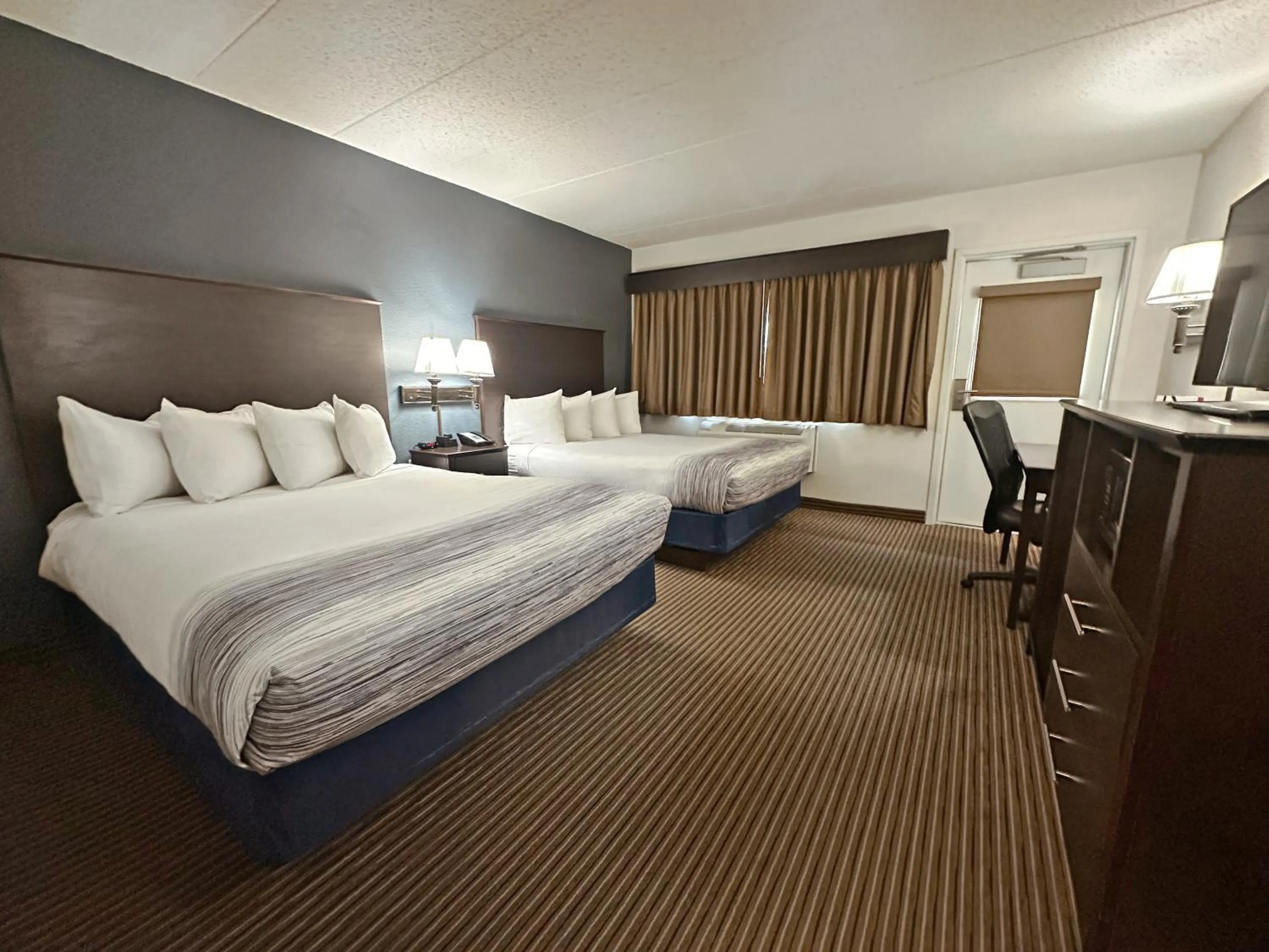 Bed in AmericInn by Wyndham Menominee
