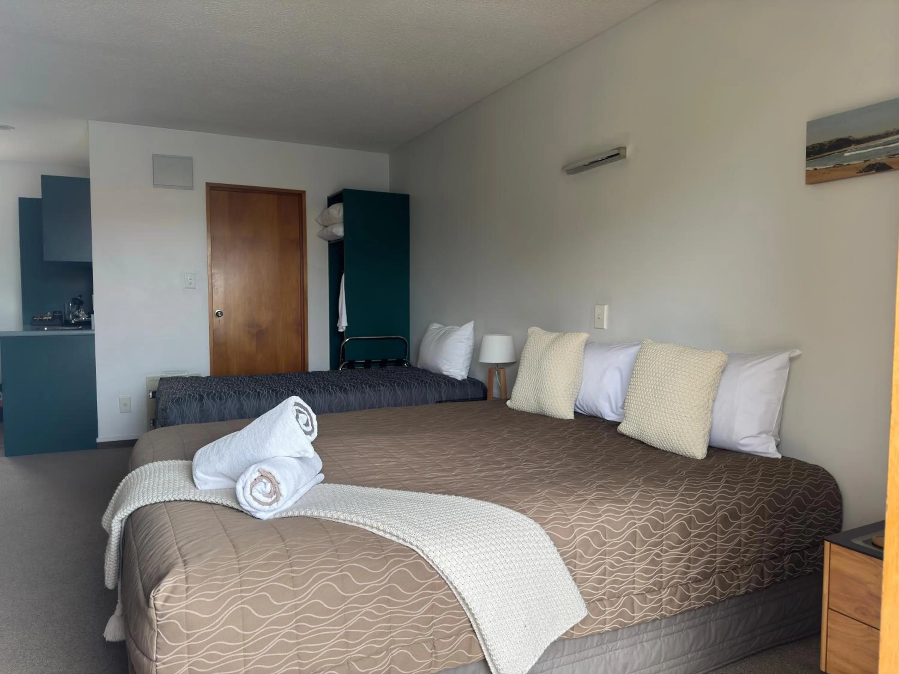 Bed in ASURE Ambassador Motor Lodge