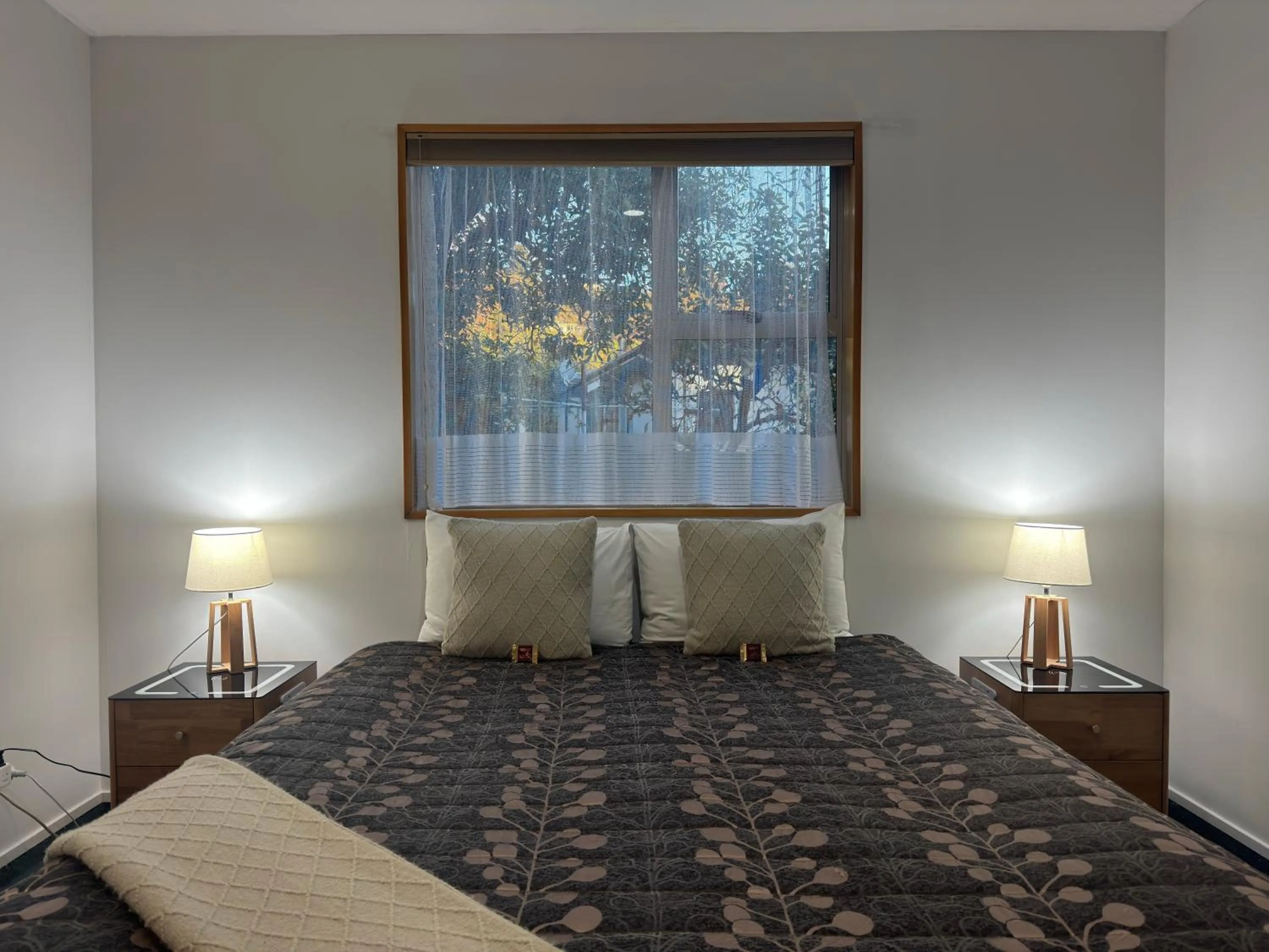 Bed in ASURE Ambassador Motor Lodge