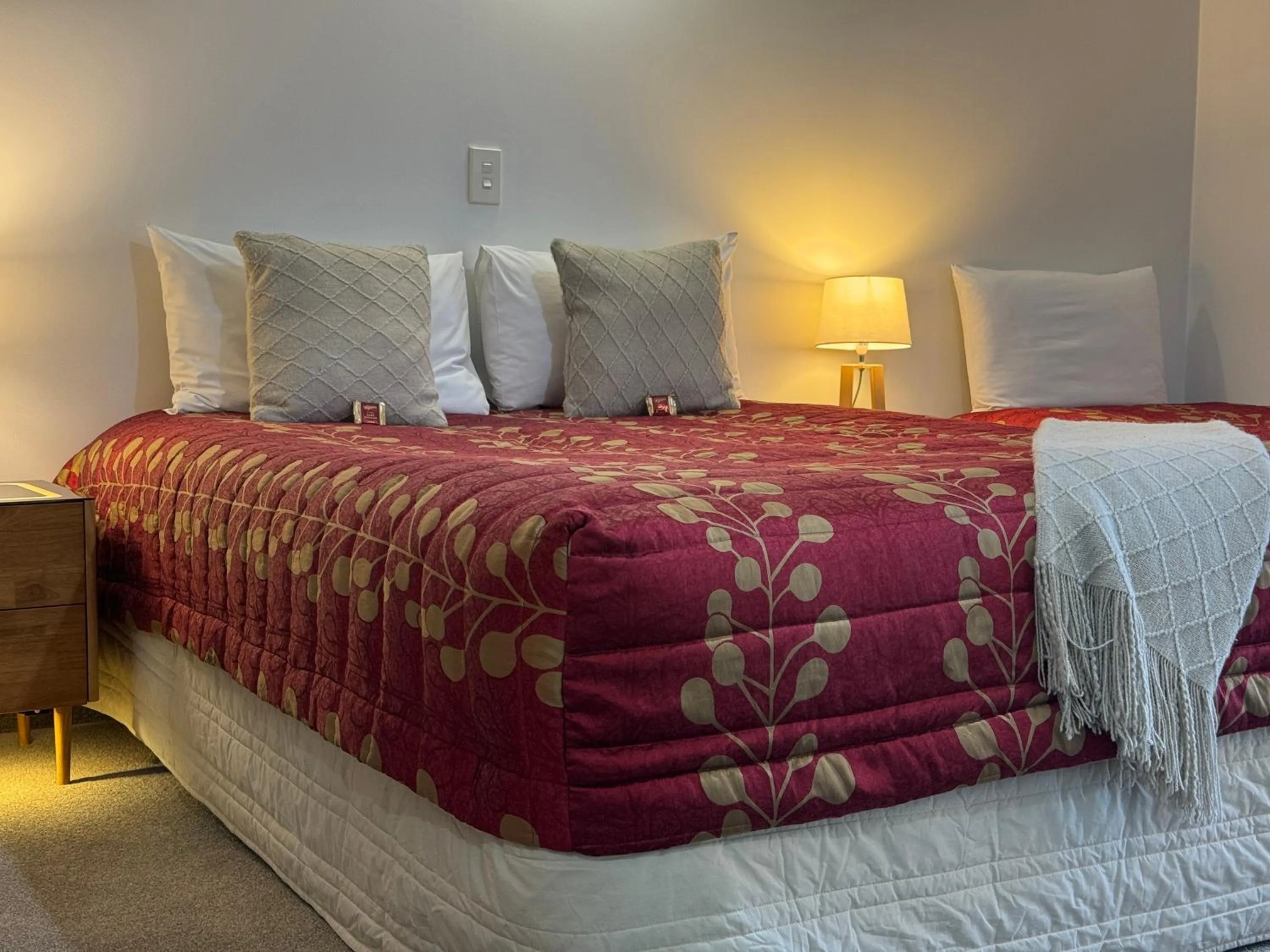 Bed in ASURE Ambassador Motor Lodge