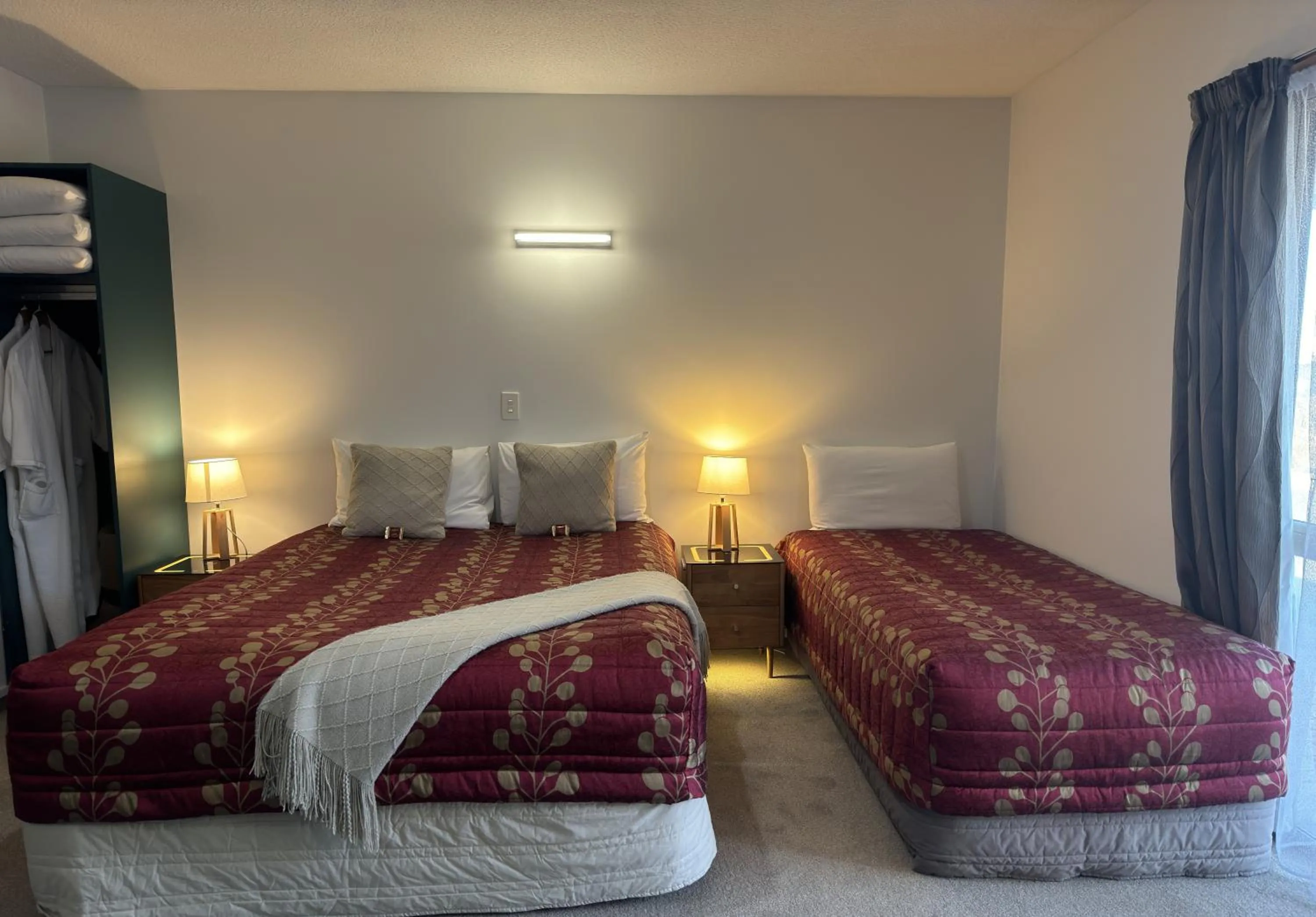 Bed in ASURE Ambassador Motor Lodge