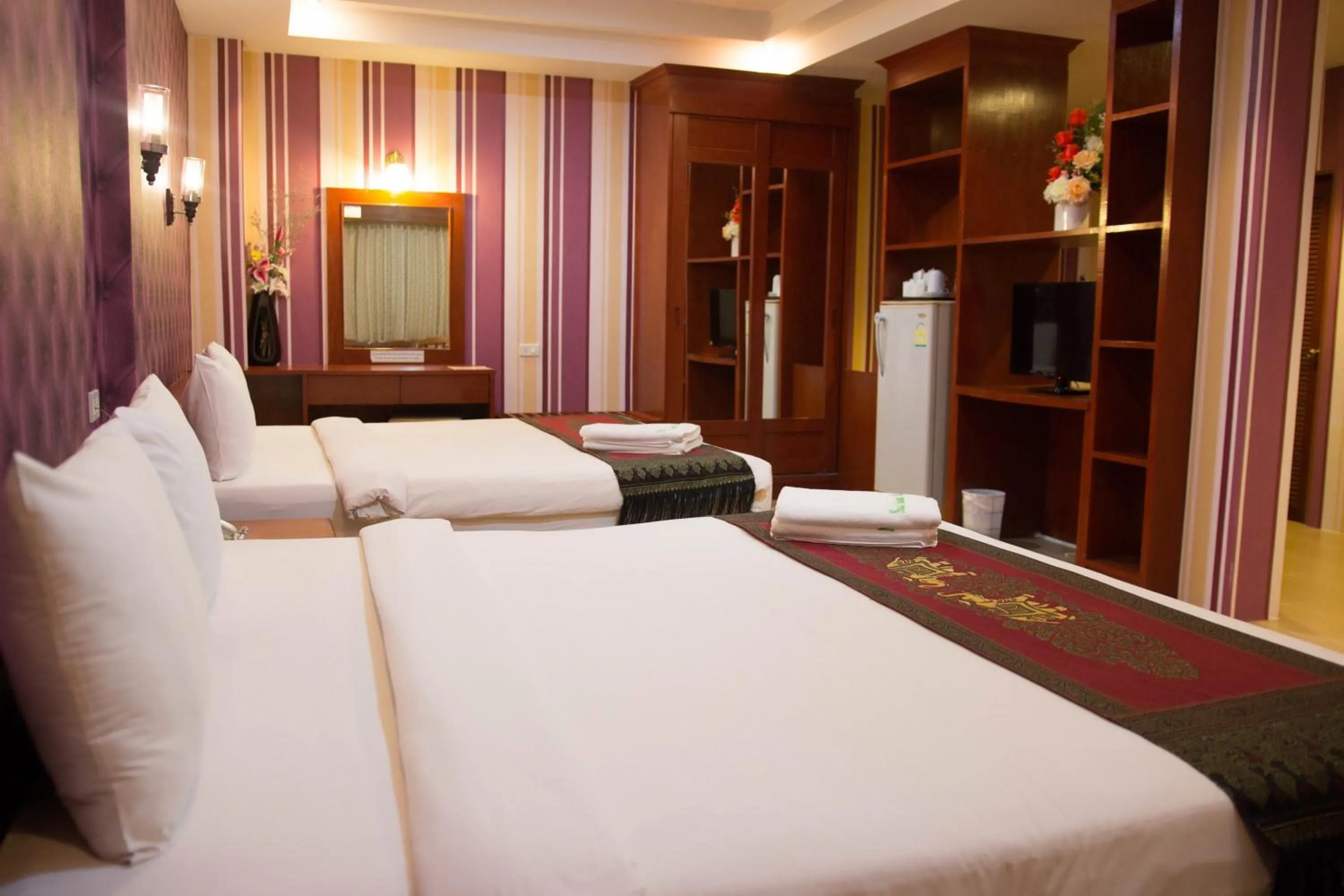 Bed in Natural Samui Hotel