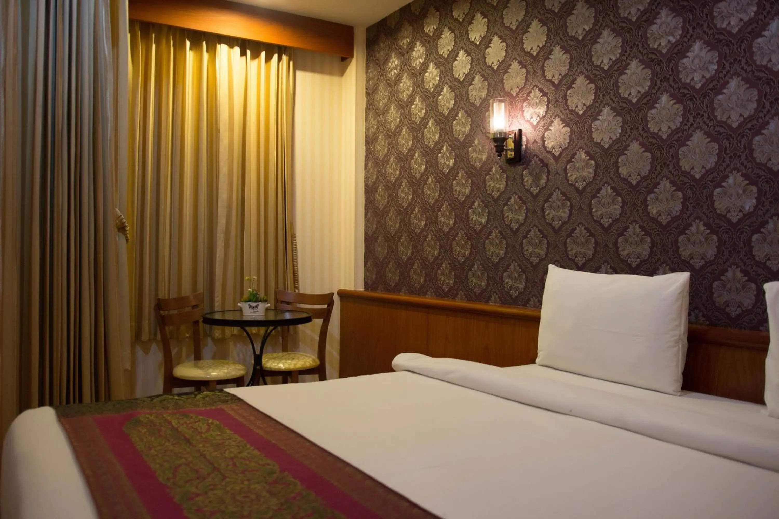 Bed in Natural Samui Hotel